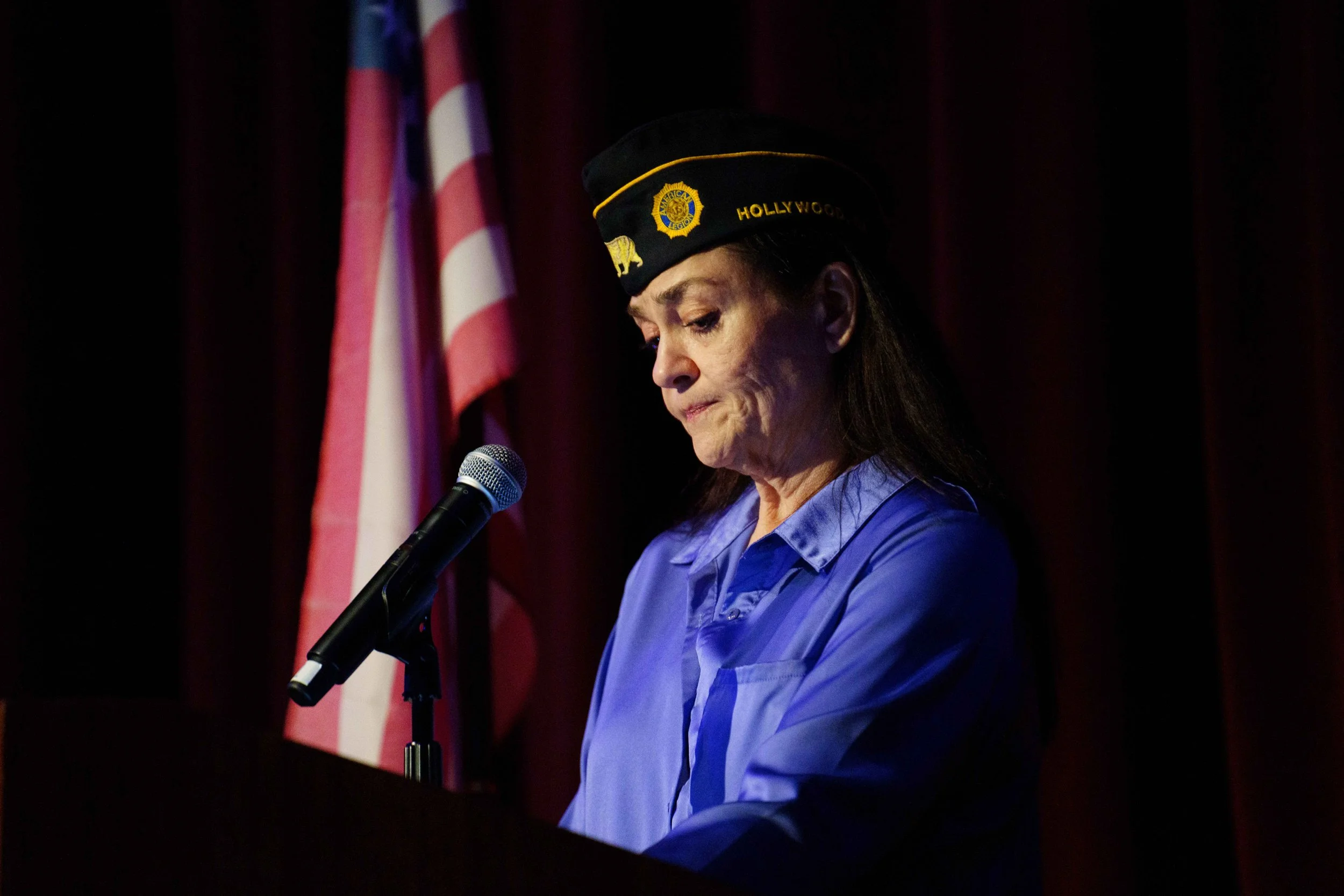  American Legion Post 43 First Vice Commander Monica Nichelson reads words from her partner, Alan: “Jere didn't just hold titles. He embodied the virtues that they represented... As the officer of law, he was the protector. Not just by profession, bu