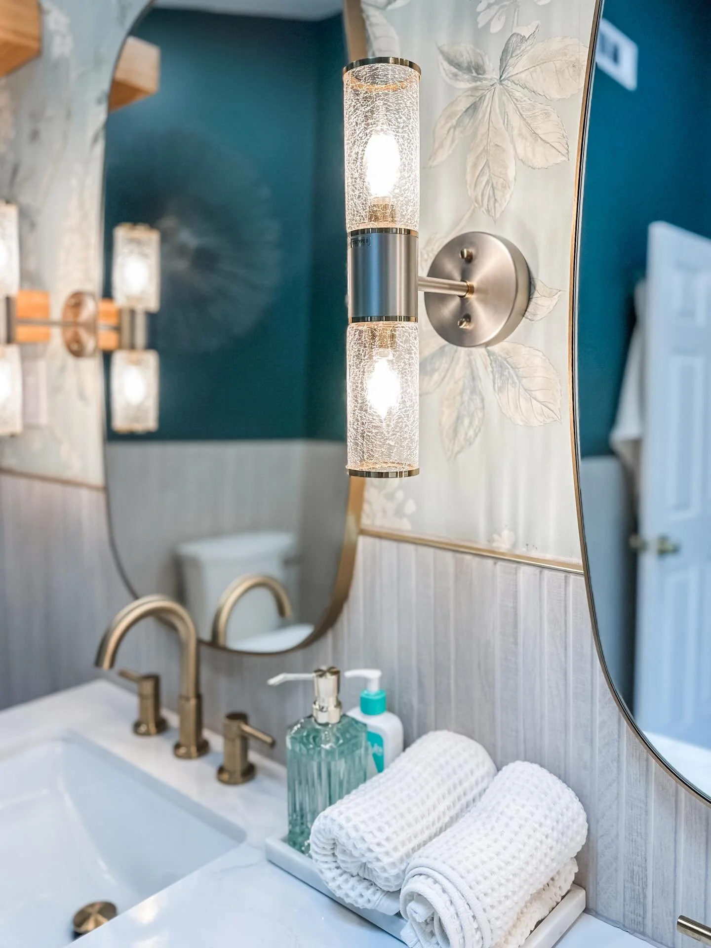 Bathroom Lighting Matters More Than You Think:

When it comes to bathrooms, vanity sconces are a game-changer. While above-mirror lighting is common, it often creates harsh shadows and uneven light.

Why sconces beside the mirror are better:
&bull; P