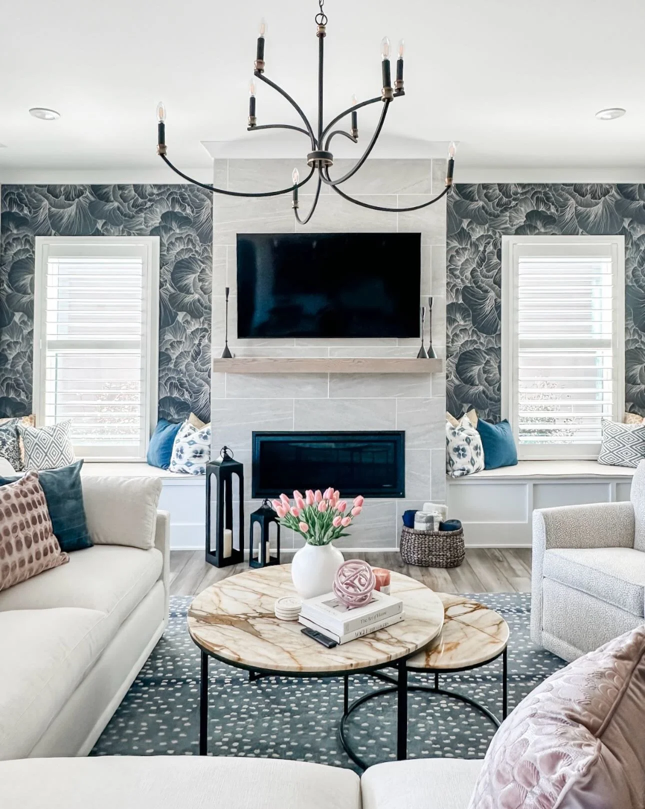 Moody, modern, and just the right amount of bold!

This living room went from safe to statement by leaning into the colors our client already loved in her rug&mdash;and letting them lead the design. We layered in a stunning wallpaper to set the tone,