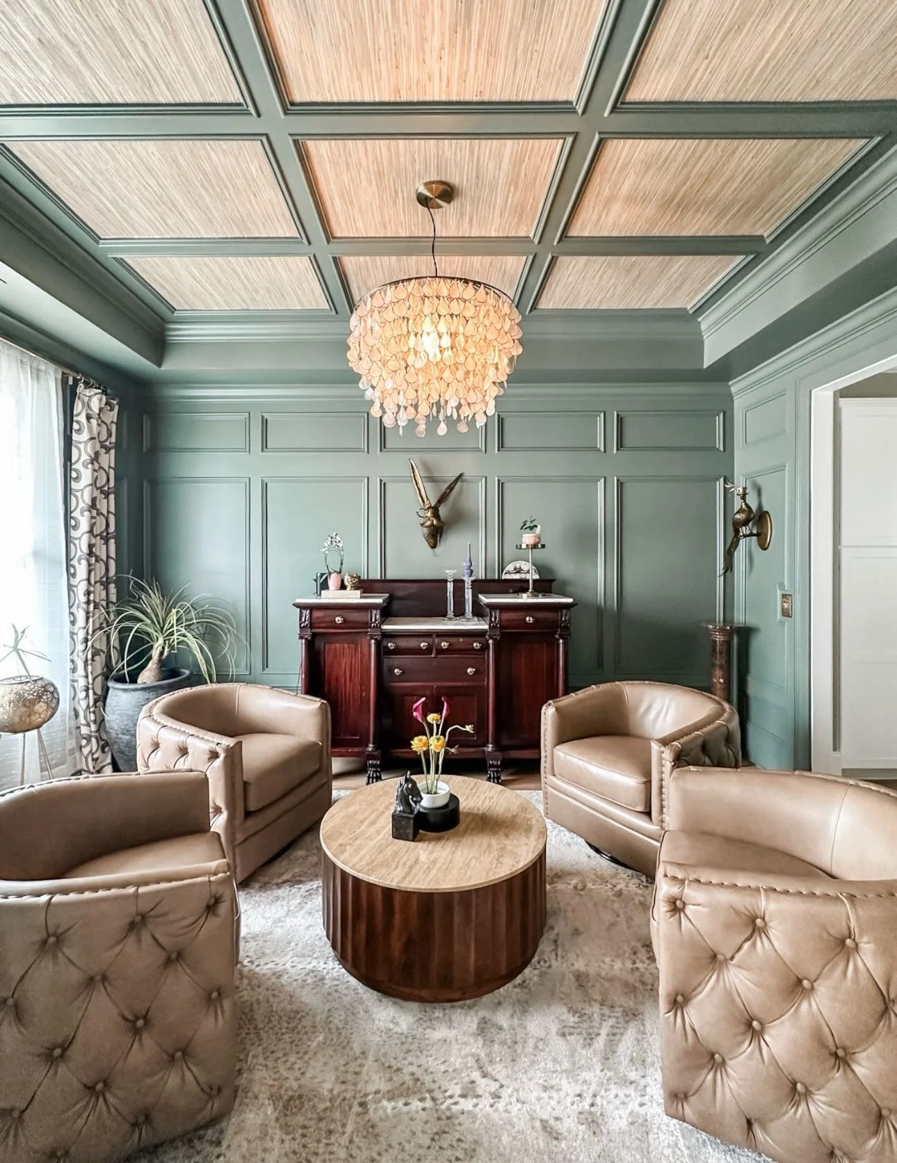 We transformed this sitting room into a sultry, speakeasy-inspired escape&mdash;where every detail invites you to linger a little longer. The real showstopper? Grasscloth wallpaper on the ceiling, drawing your eye up and letting that gorgeous trim wo
