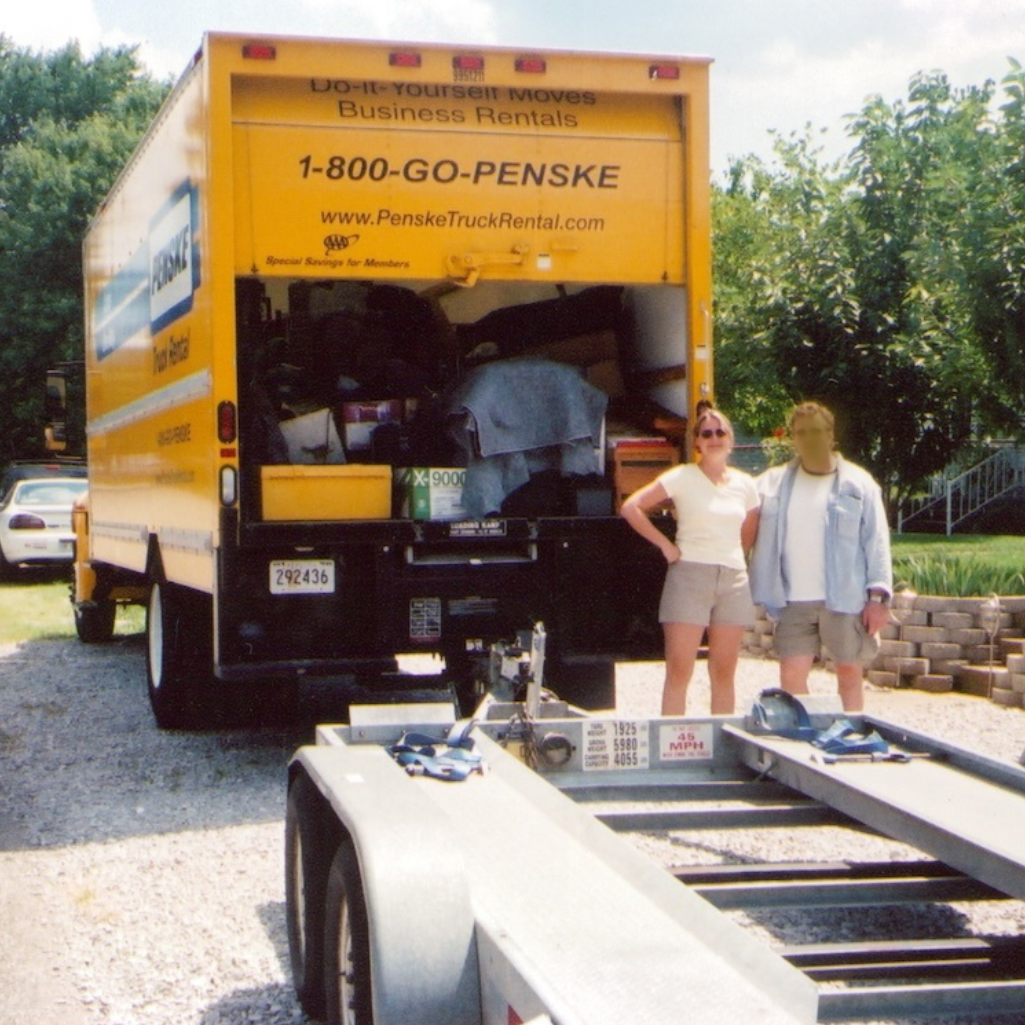 Old photo of SJ Hodges and John standing in front of a moving truck
