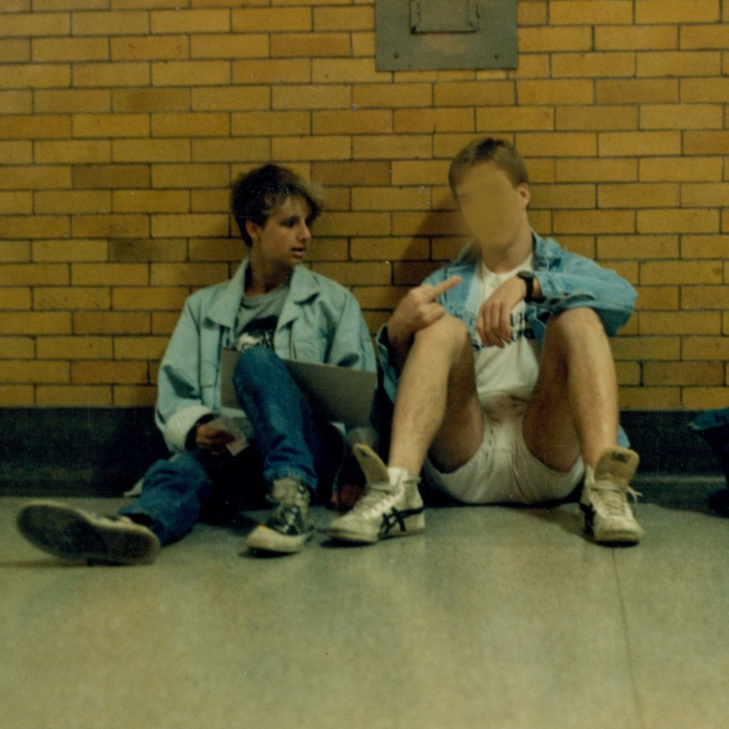 Old photo of SJ Hodges & John sitting on the ground.