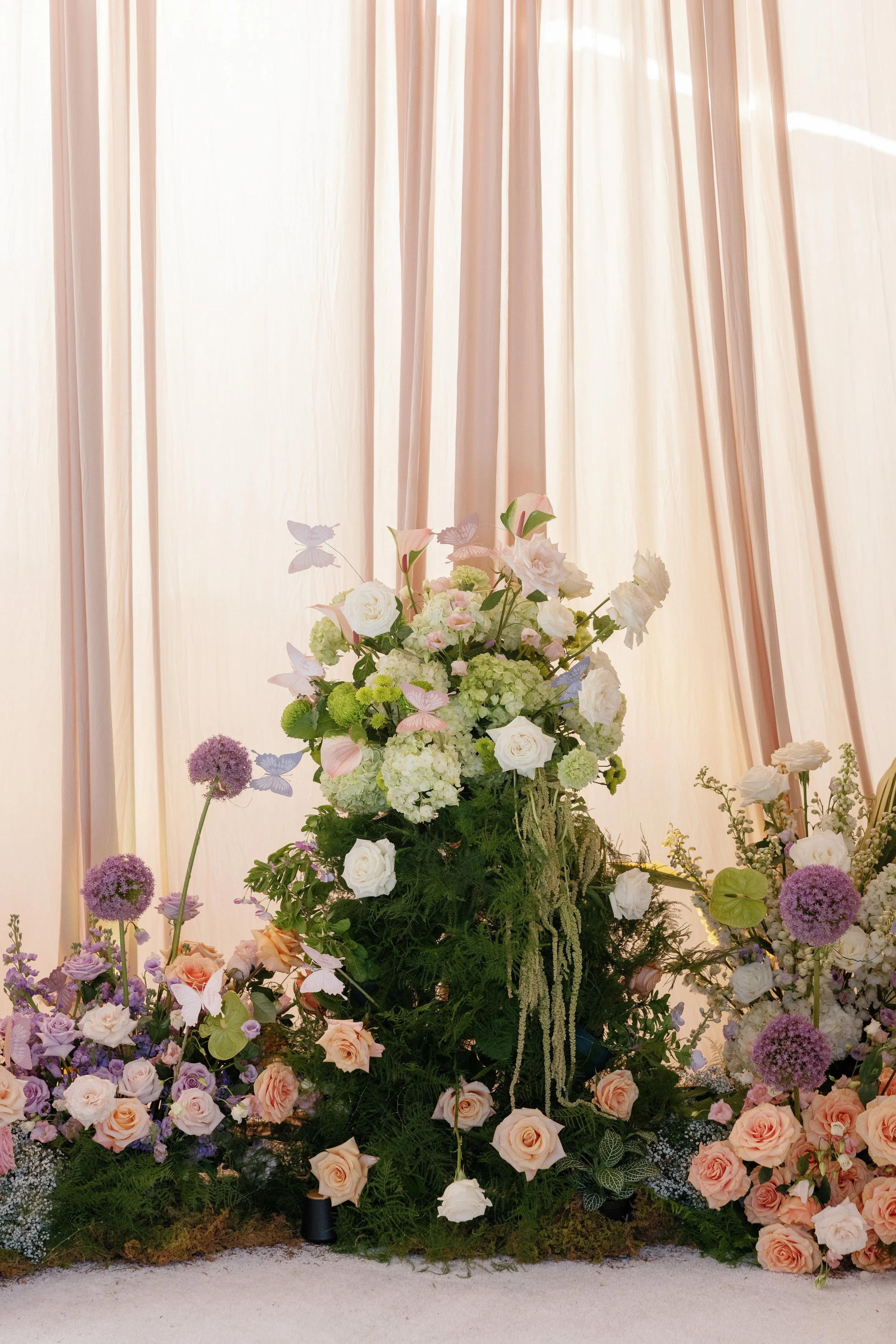 Paper Butterflies on Floral Arrangement for Wedding Seating Assignments or Escort Cards