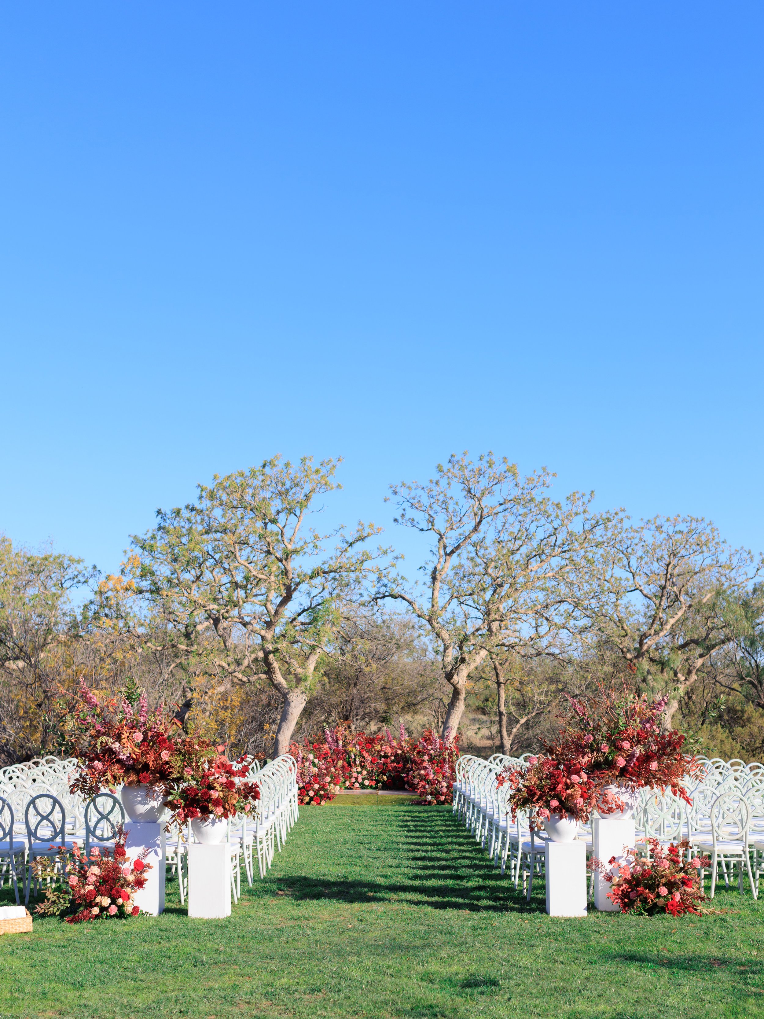 Private Estate Ranch Wedding Ceremony with Red and Burgundy Florals Down the Aisle