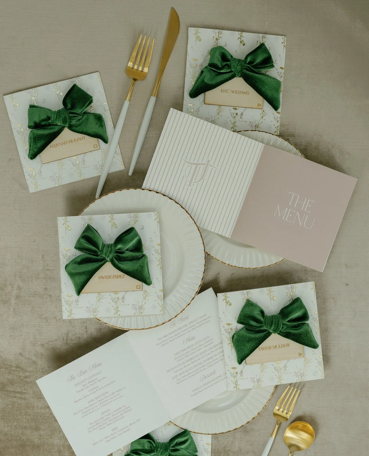 A menu that&rsquo;s as layered as the celebration itself.This booklet opens with a pastel floral cover touched with gold foil, tied with a green velvet bow, and topped with a laser-engraved place card. Inside, the couple&rsquo;s monogram and multi-co