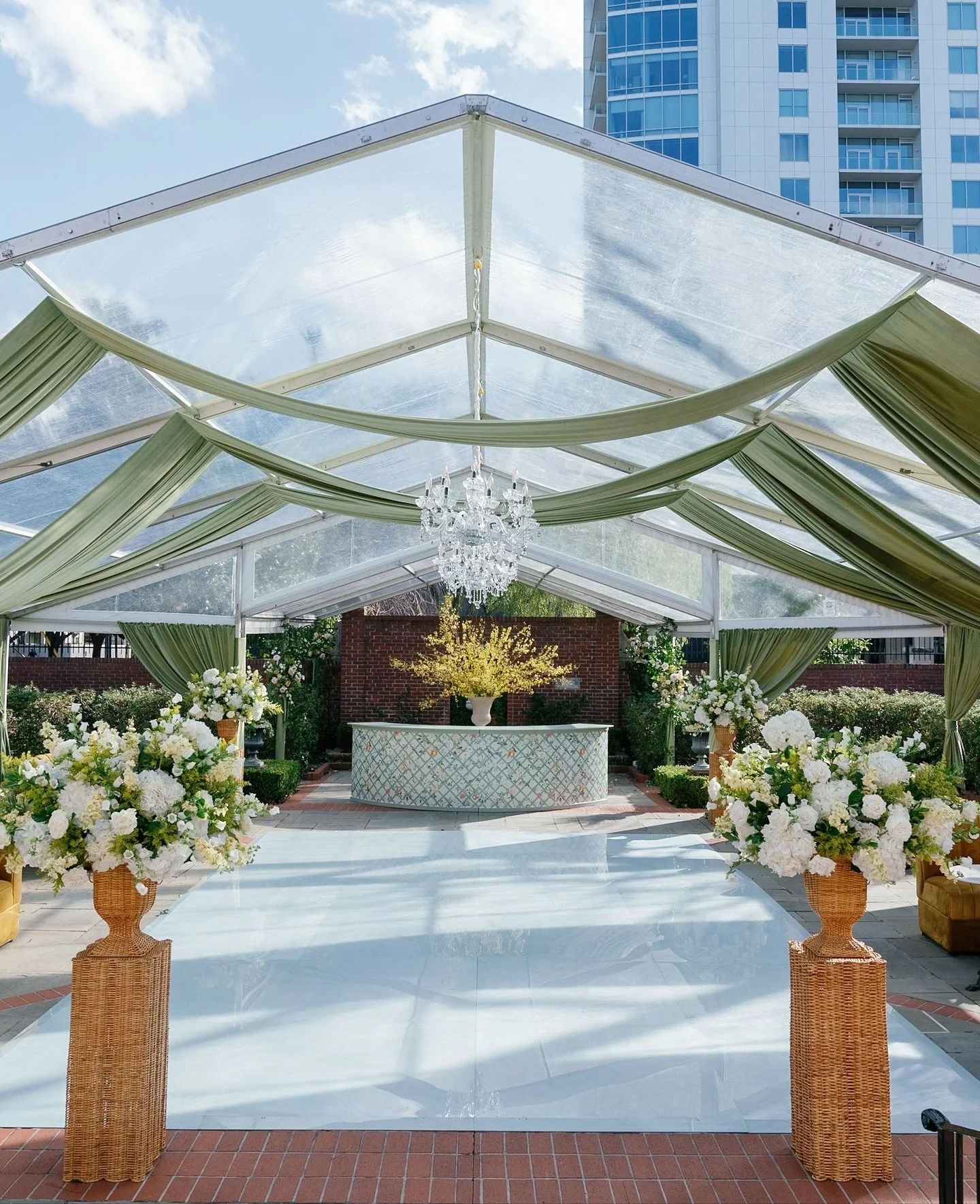 For Caroline &amp; Josh, the garden became a muse. We designed a custom watercolor pattern alive with trees, birds, florals, and citrus, echoing the grounds where they celebrated. Under the tented reception, that artwork wove its way into every detai