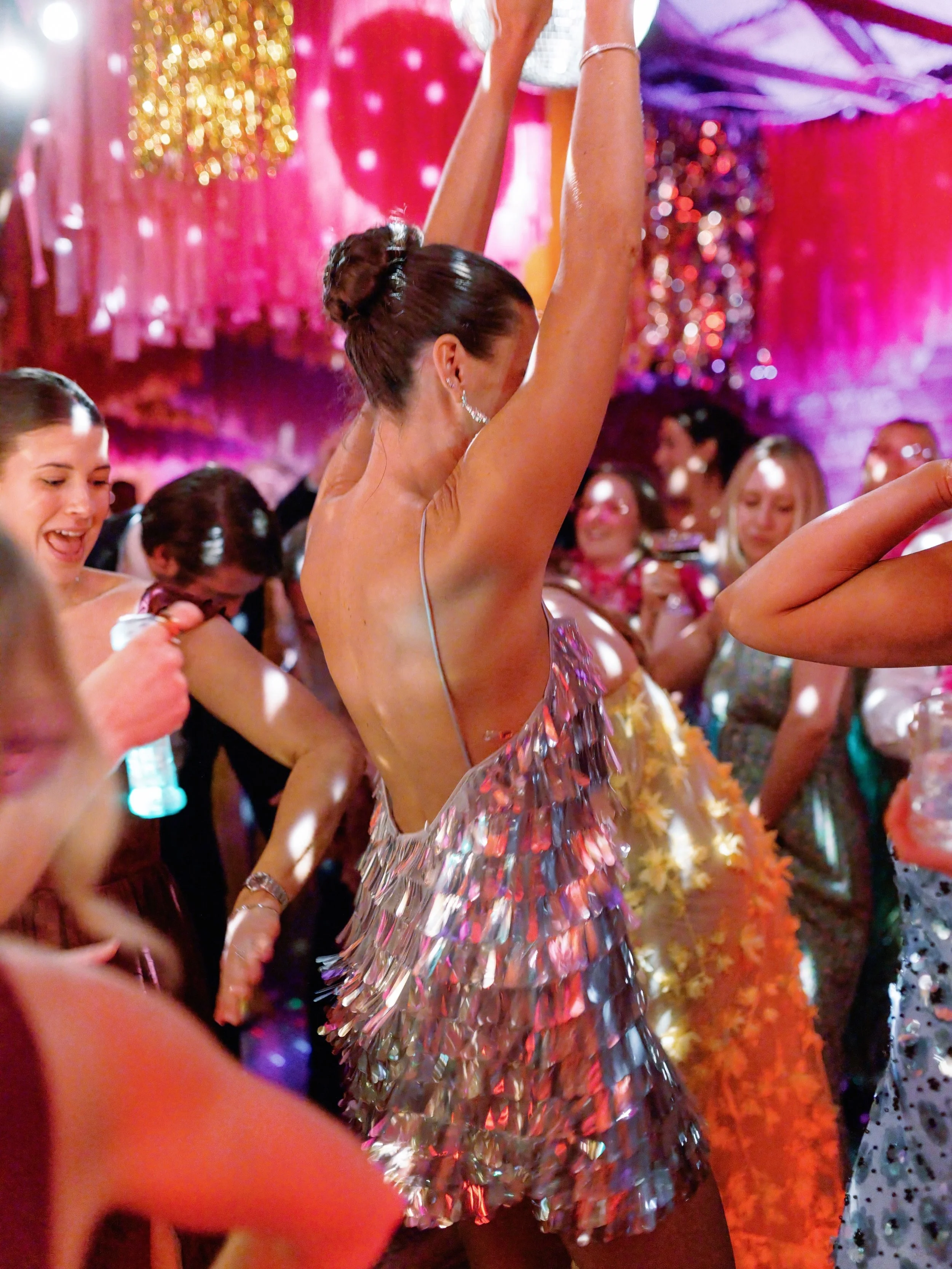 Maggie and Erik&rsquo;s after party was an entire electric disco cowgirl fever dream. Neon pink acrylic, edge-lit signage, metallic tinsel dripping from the ceiling, boots on the dance floor, espresso martinis in hand, and a glowing &ldquo;everything