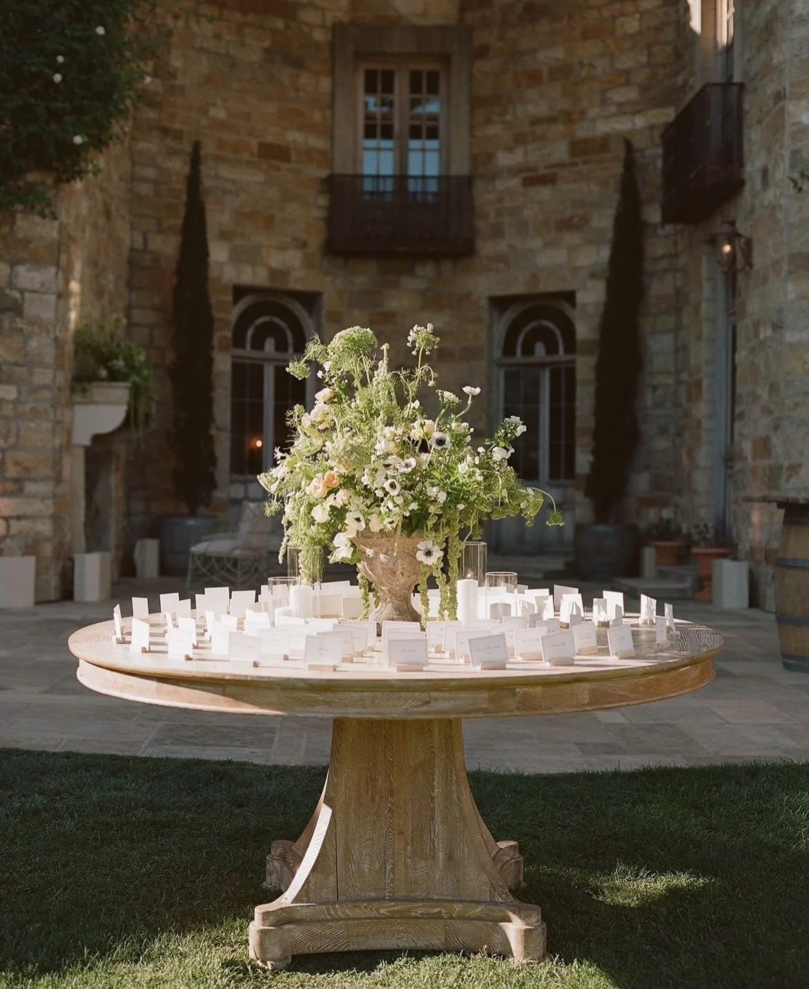 An outdoor celebration at Sunstone Winery, with an easy al fresco feel throughout. Escort cards set the tone on arrival, while the reception unfolded under string lights in a crisp white and green palette. Thoughtful paper details and a relaxed viney
