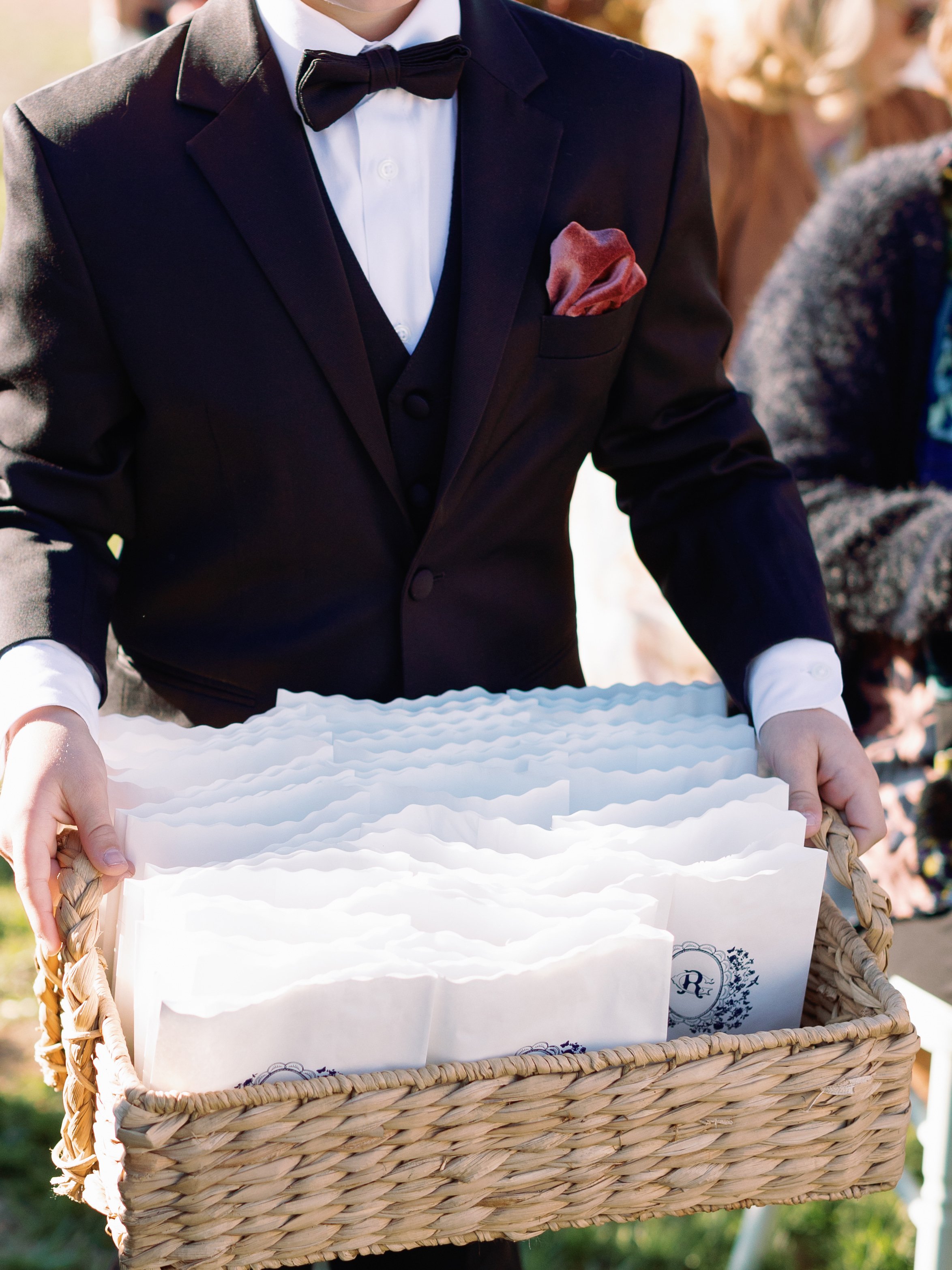 Flower Petal Bags for Wedding Ceremony in Blue with Scalloped Floral and Bird Monogram Being Passed out by Usher