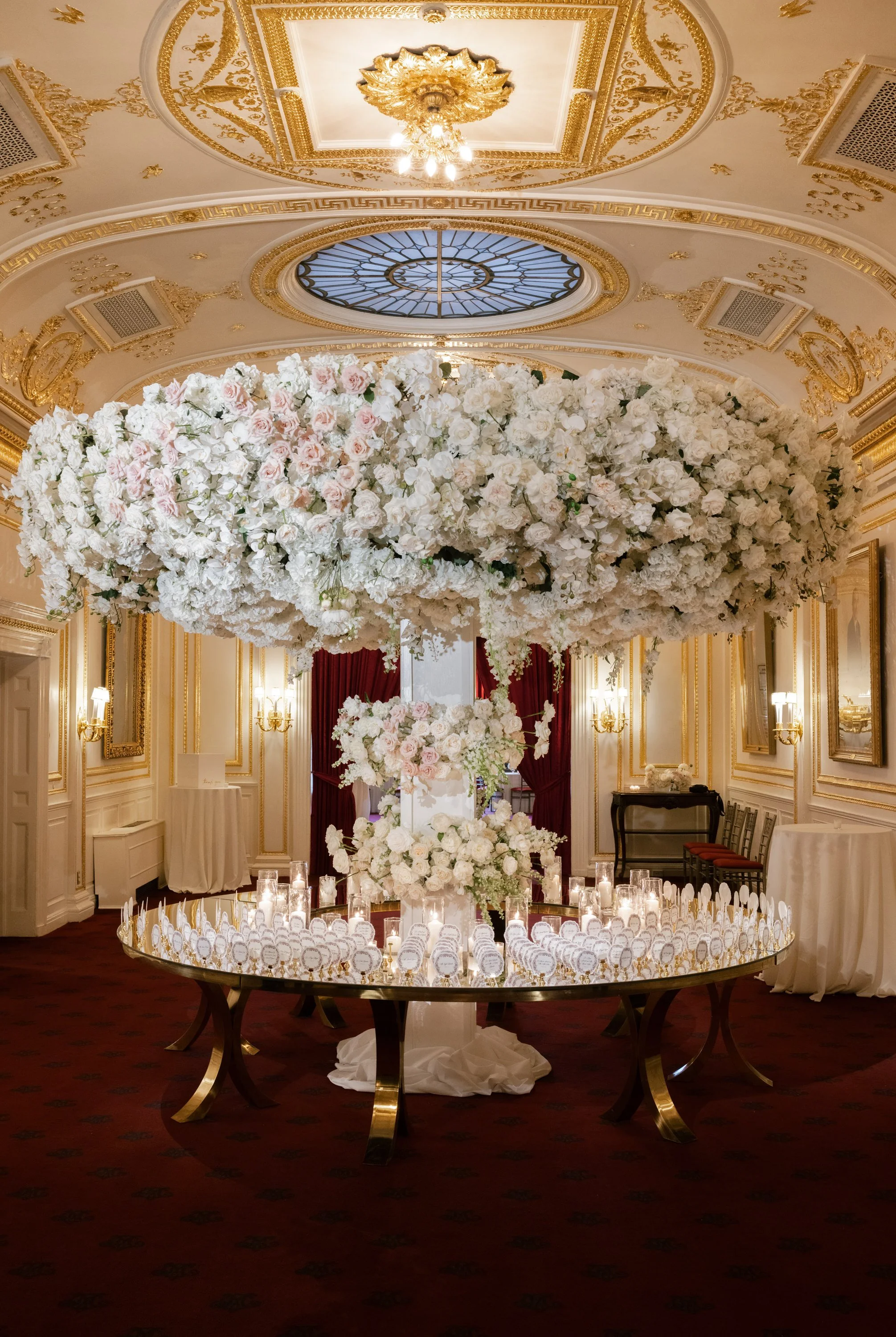 Die Cut Wedding Escort Cards with Vintage Inspired Shape and Frame in Black and Pink for Metropolitan Club in New York Displayed on Circular Mirror Table with Hanging Florals