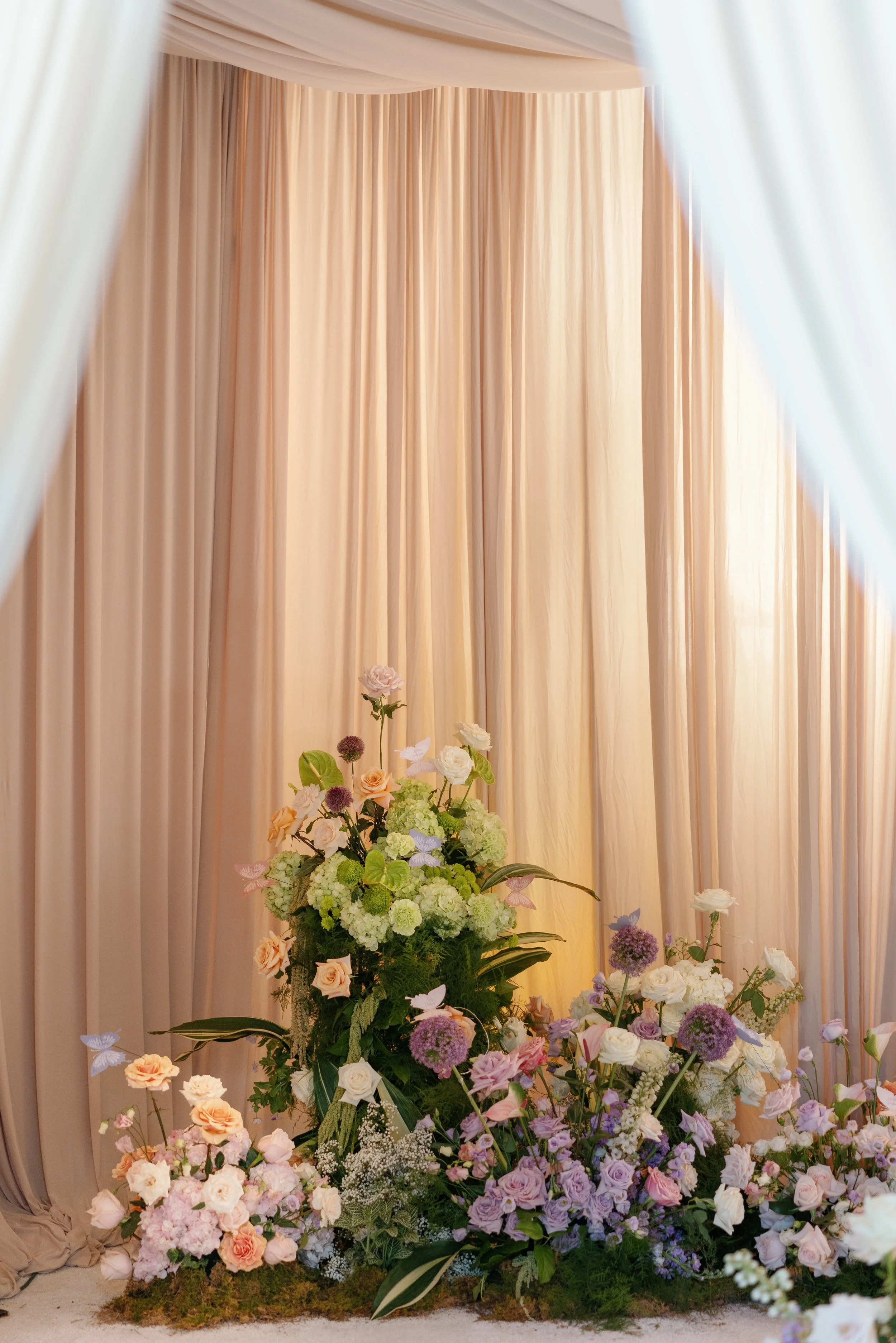 Paper Butterflies on Floral Arrangement for Wedding Seating Assignments or Escort Cards
