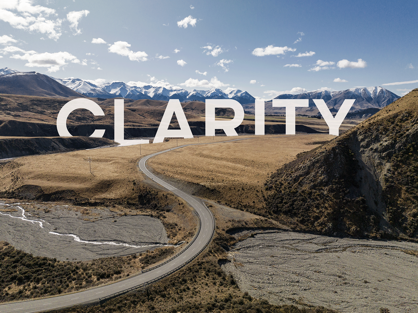 A beautiful landscape image of a country road in New Zealand, snaking through the landscape towards snow capped mountains in the distance_the word Clarity is in white set against the landscape.