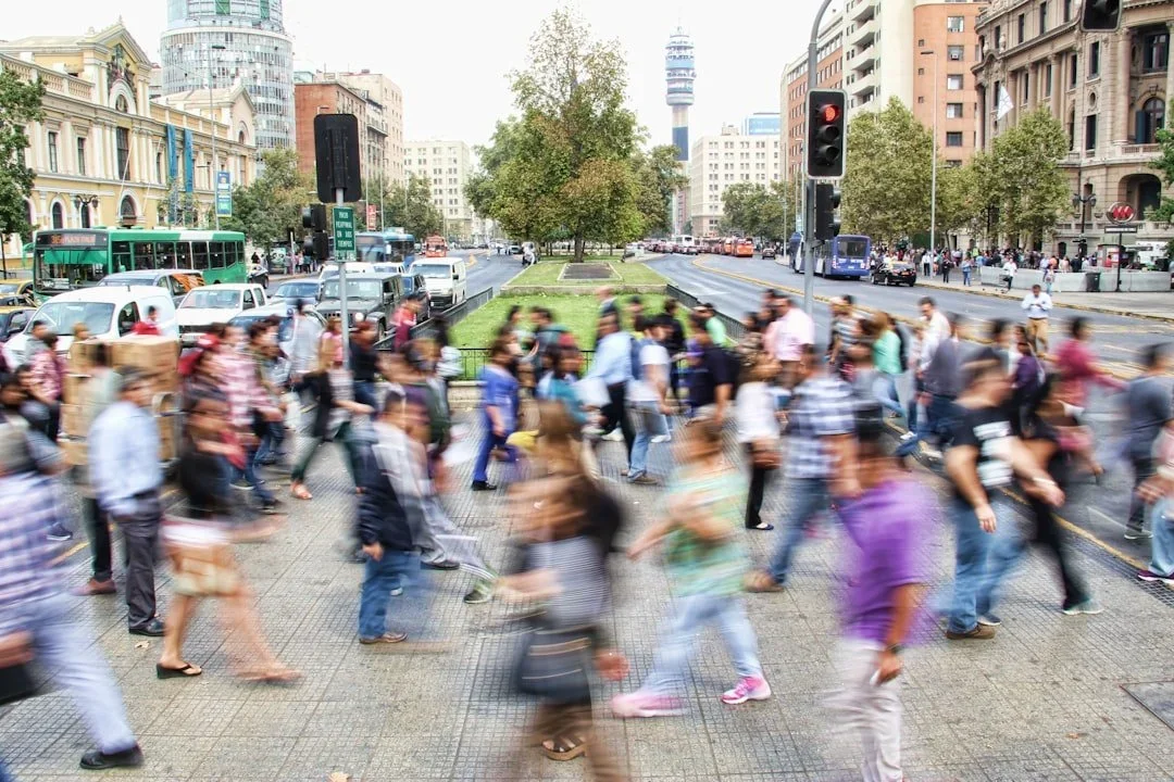 Crowd of people walking across a street