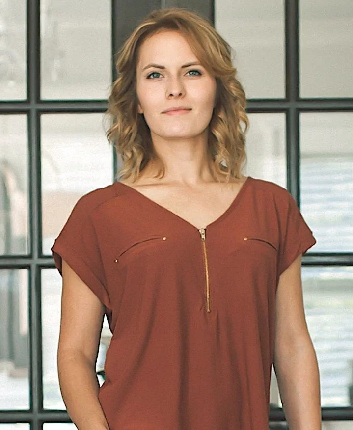 caucasian woman wearing red blouse.