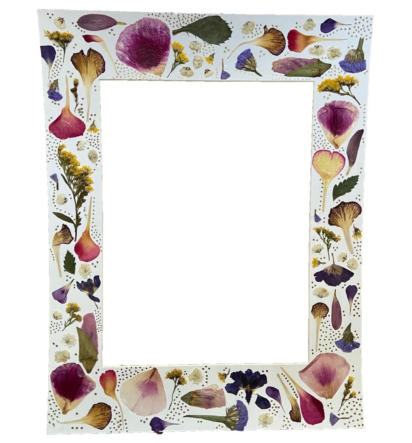 Decorative photo frame bordered with pressed and dried flowers and leaves, including pink, purple, yellow, and brown blooms on a white background.