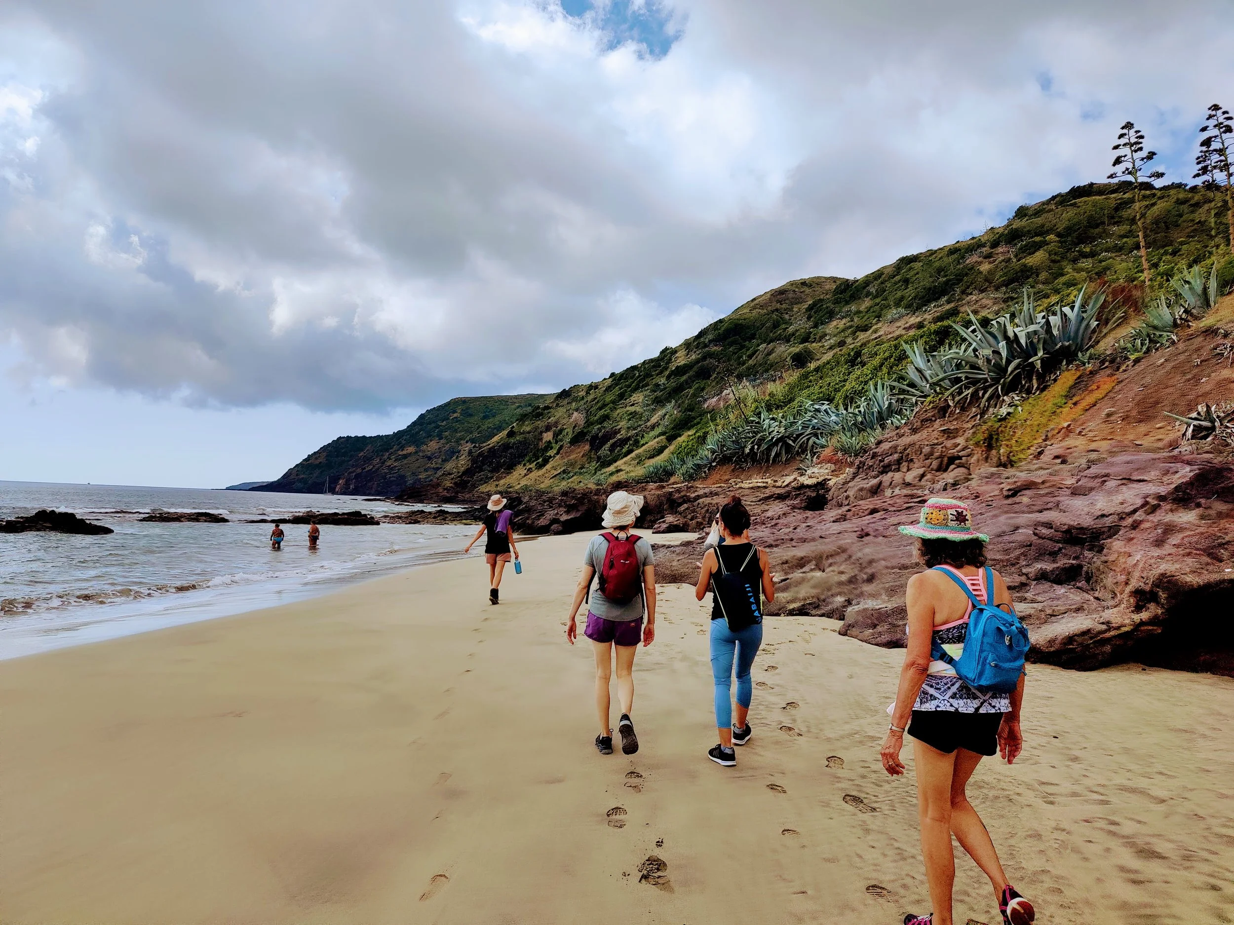 Yoga group walking on a beach in Santa Maria Azores