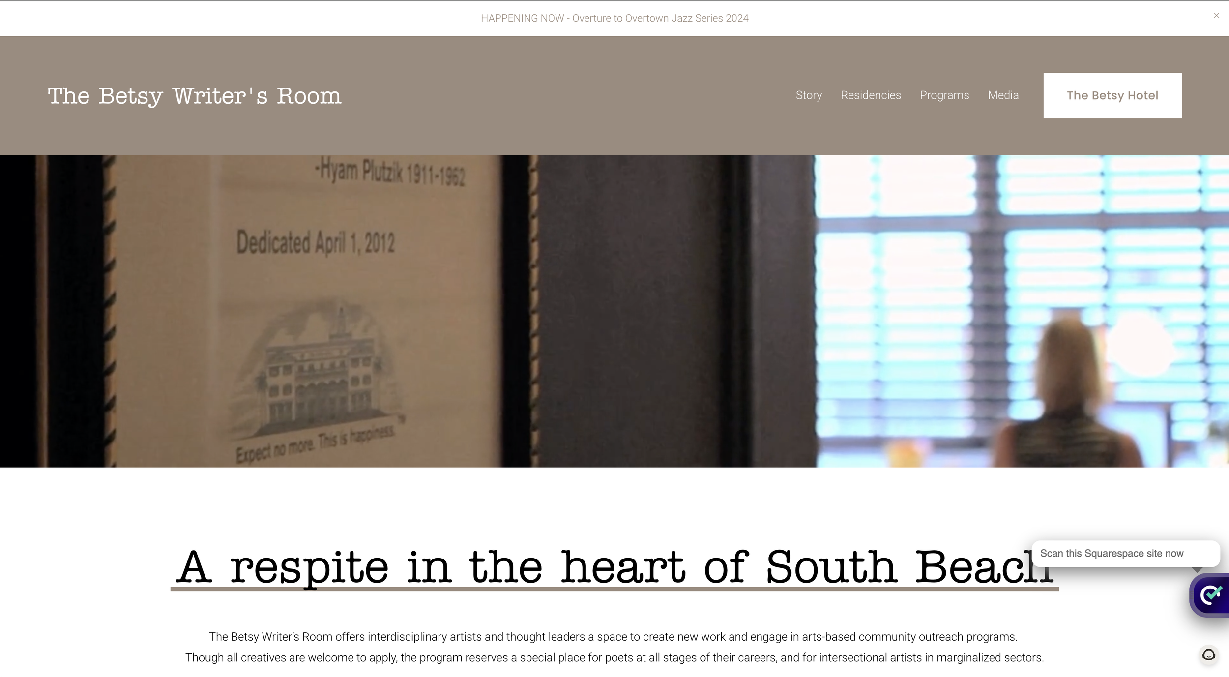 Screenshot of "The Betsy Writer's Room" webpage with a blurred background, headline reading "A respite in the heart of South Beach," and a description of the program for artists and poets in South Beach.