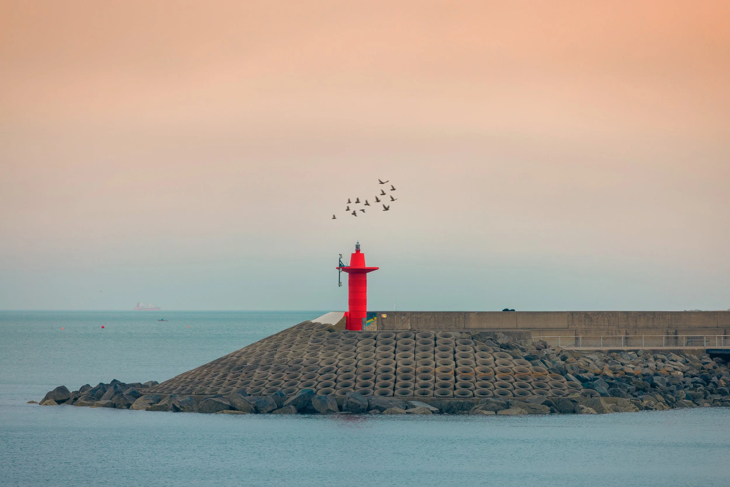 A cinematic still, featuring the lighthouse on Bangors pier, at sunset. Taken by Tru°North during a photo walk.