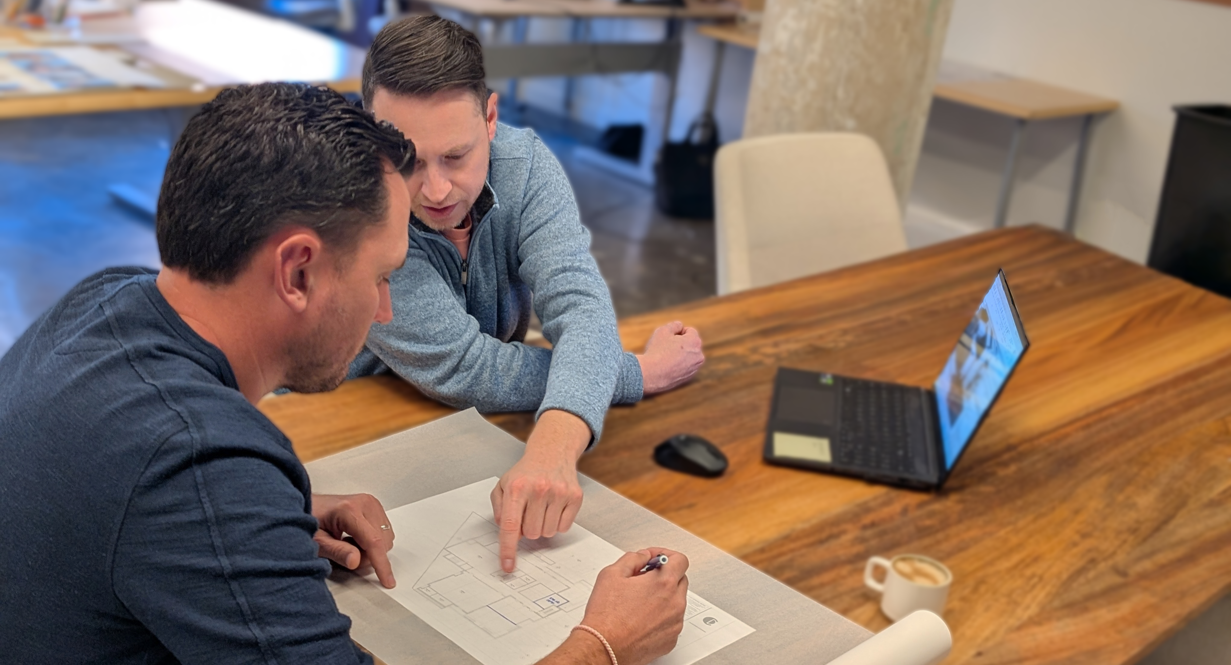 Two architects reviewing drawings and discussing planning and programming for an ambulatory surgery center 