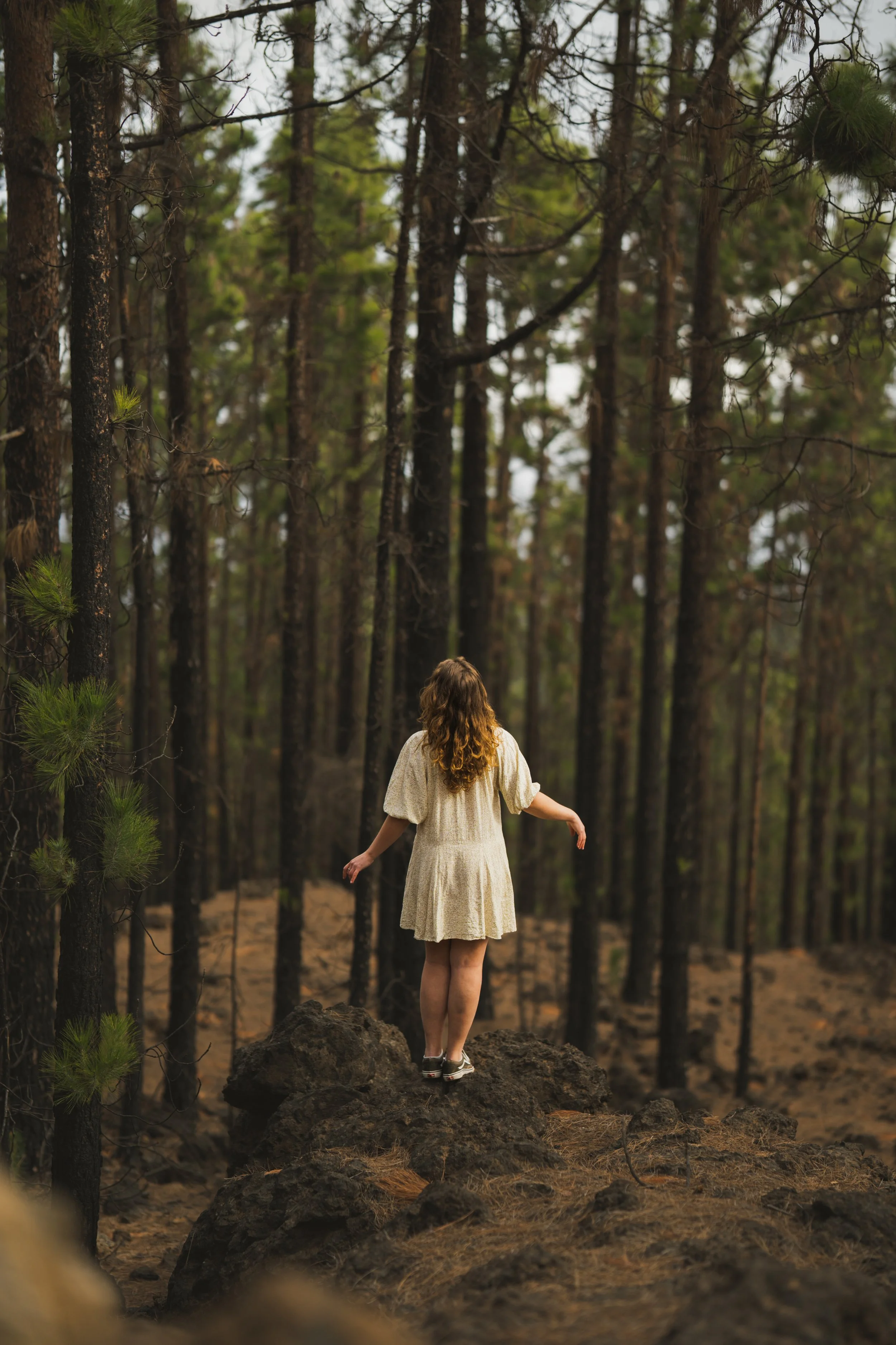 Girl in dark forest with little white dress