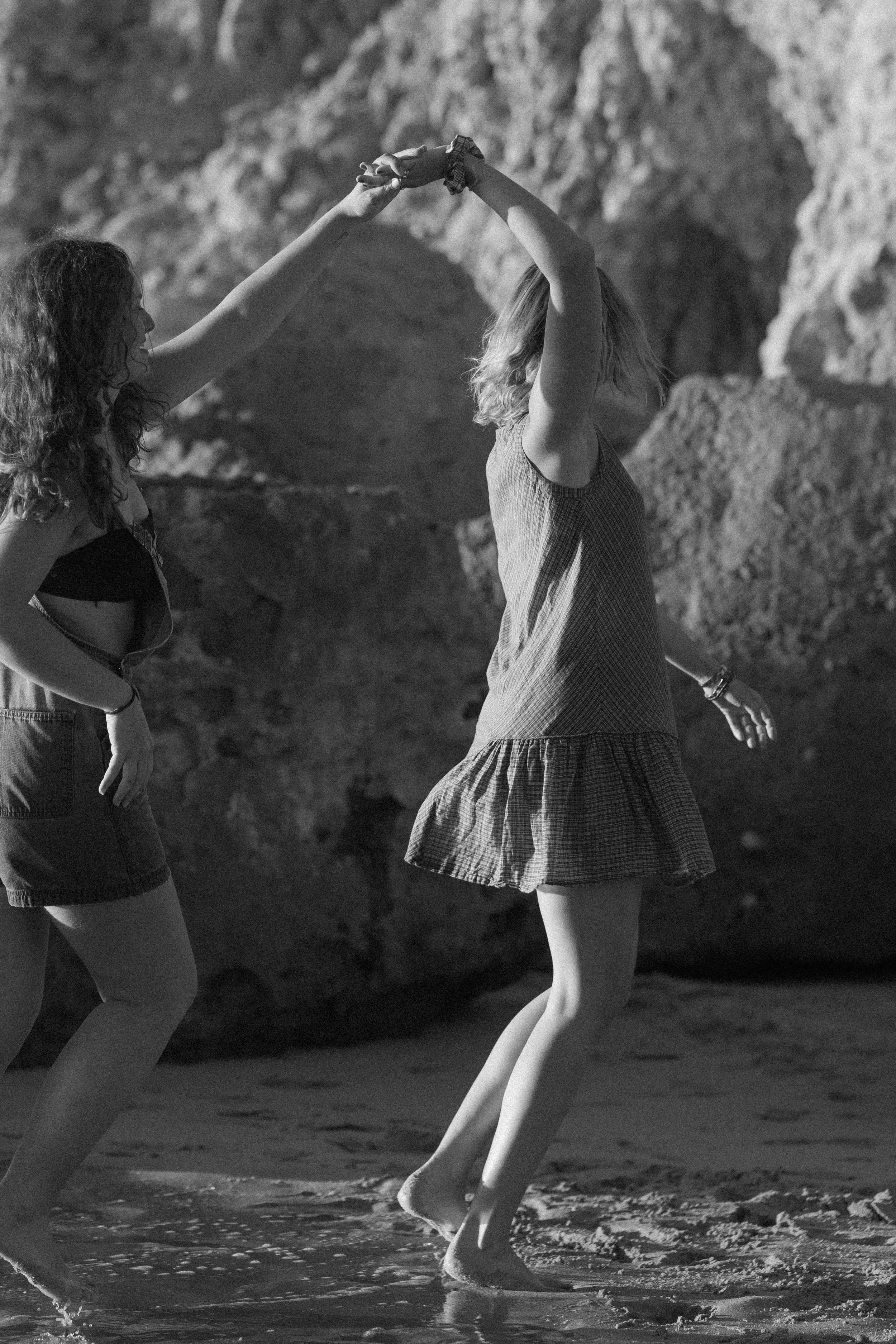Girls dancing on the beach black & white