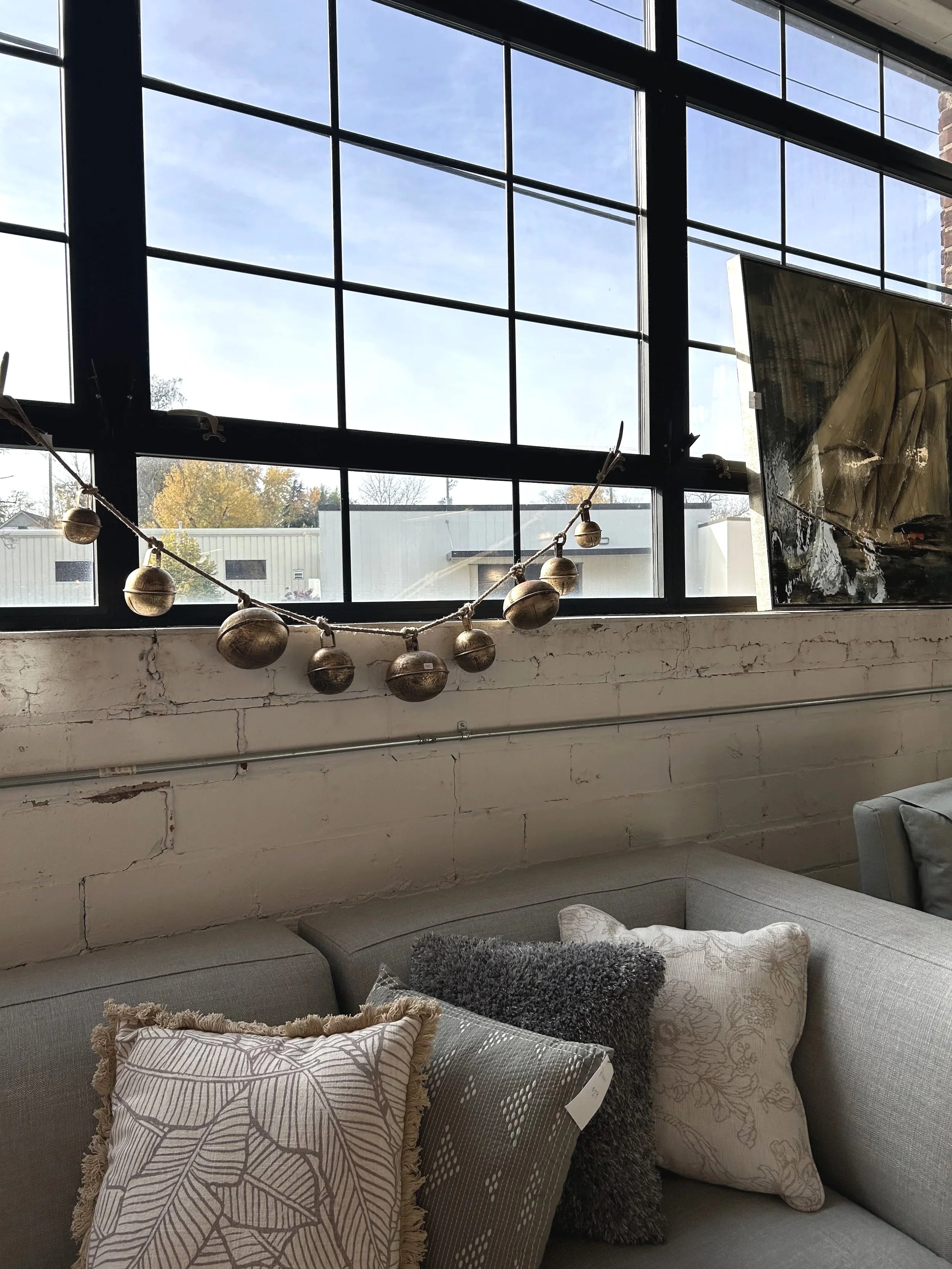 Alcove Interiors has unique holiday decor in our rustic warehouse boutique- including these oversized bells on a garland.