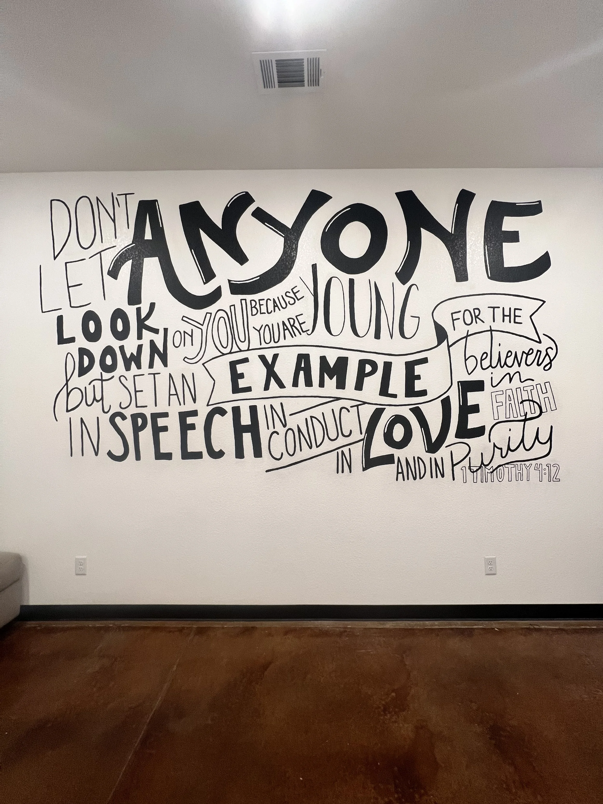 Inspirational quote wall art with black and white typography reading: "Don't let anyone look down on you because you are young, but set an example for the believers in speech, conduct, love, faith, and purity. 1 Timothy 4:12."