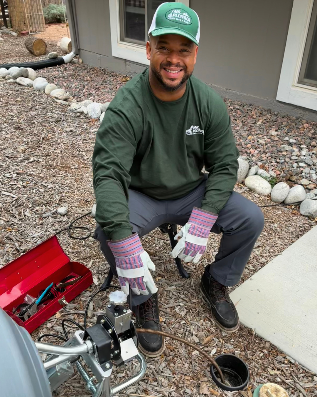 George Mckay, aka Mr. Plunger, performing a sewer clean from a residential mainline cleanout in the front yard of a home.