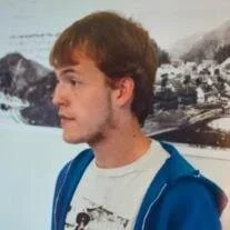 A white person in a blue hoodie.