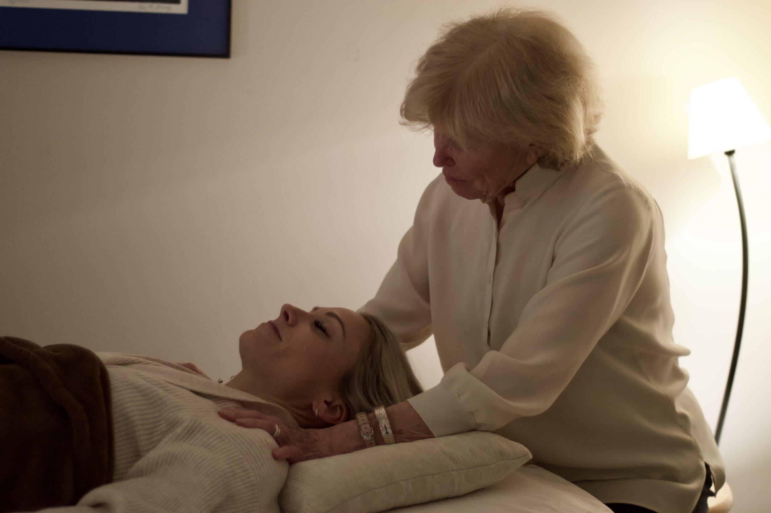 An Energy Healing session performed by Susan Austin-Crumpton on a table in a warm, softly lit room.