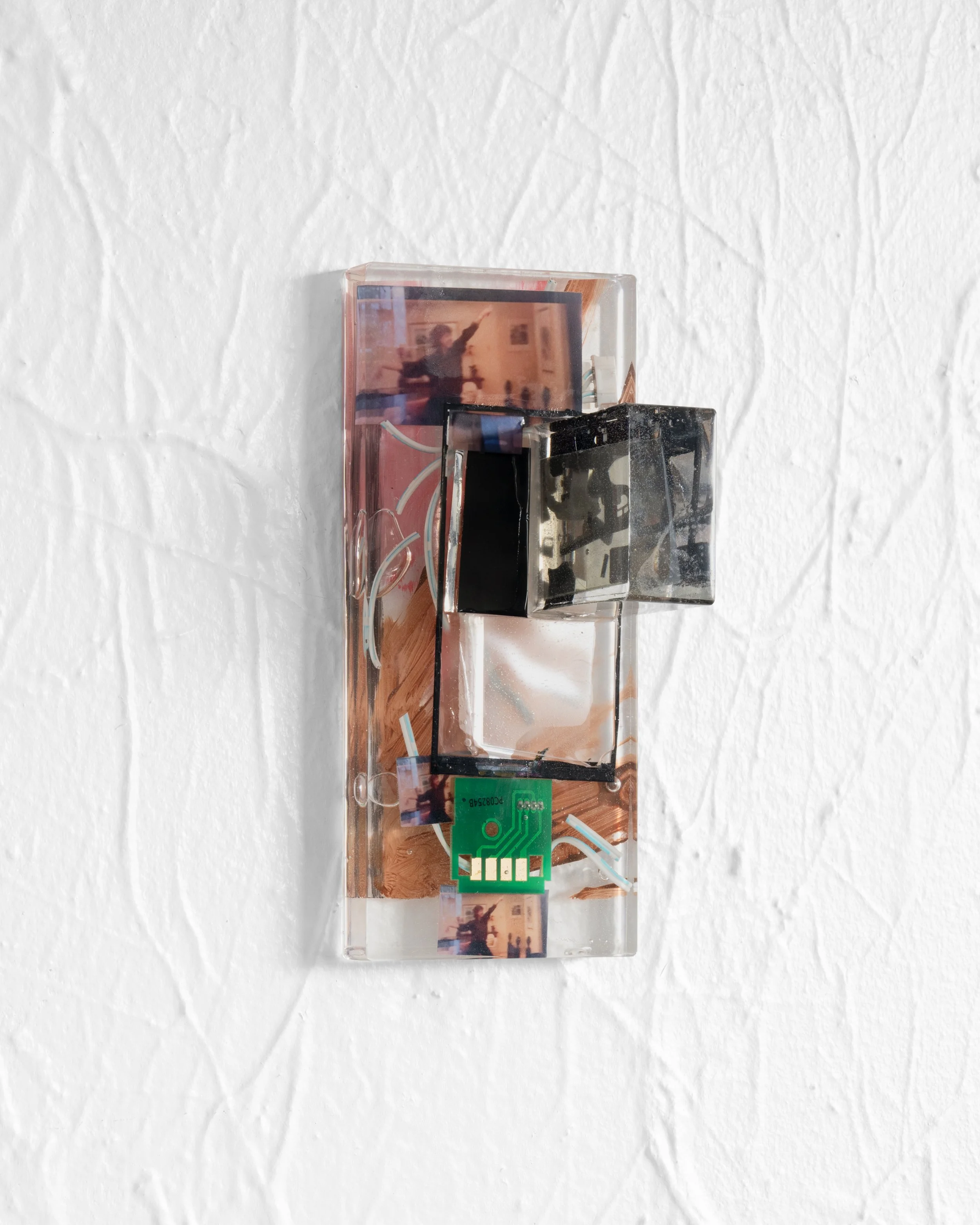 Maddie Butler
 IMG_2925.m4v (wild horses brown) , 2025
E-waste, inkjet prints, resin, paint
7 ⅛ x 3 ⅛ x 3 ¼ in.