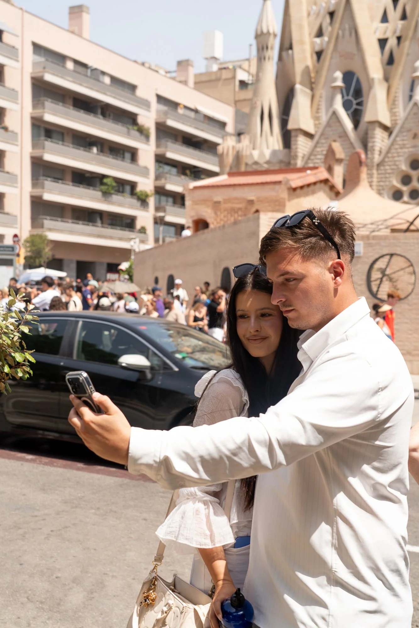 Couple taking a selfie with Sagrada Família towers in the background  — bCLPhoto