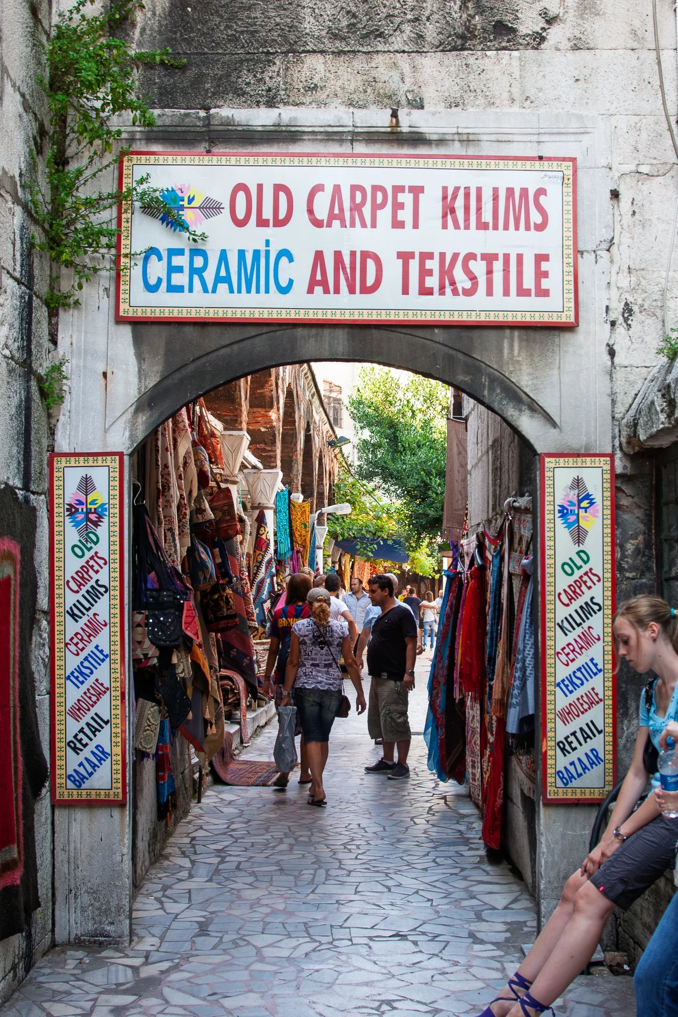 Arch signposted for carpets, kilims and ceramics opening onto a bazaar lane, Istanbul — Canon EOS 40D