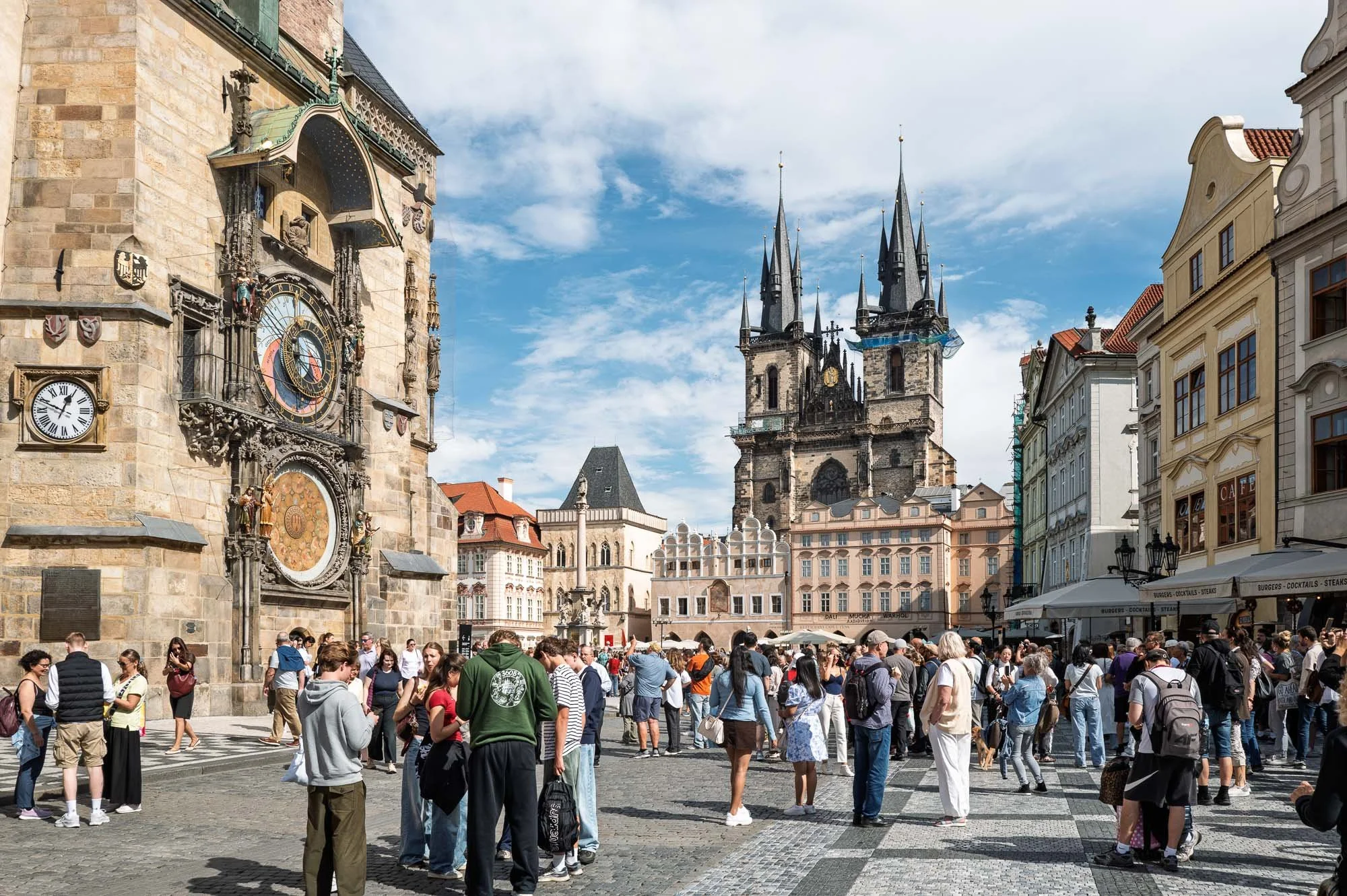 Crowd between the Astronomical Clock and Týn Church spires, Old Town Square, Prague street photography — Leica Q3