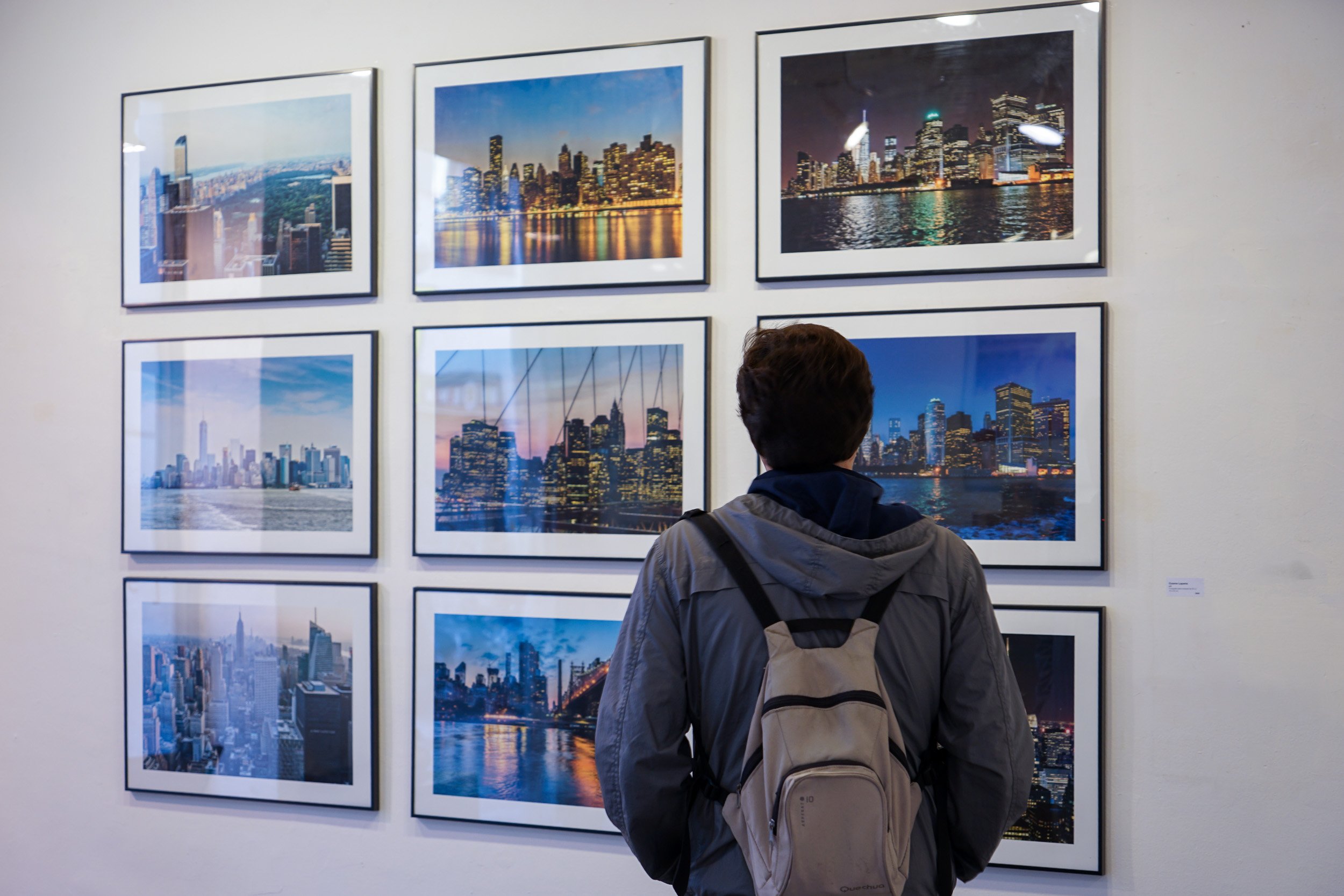 A visitor looks at Cosme Lapena's New York series at the En Sèrie exhibition, espai [b], Barcelona, 2016.