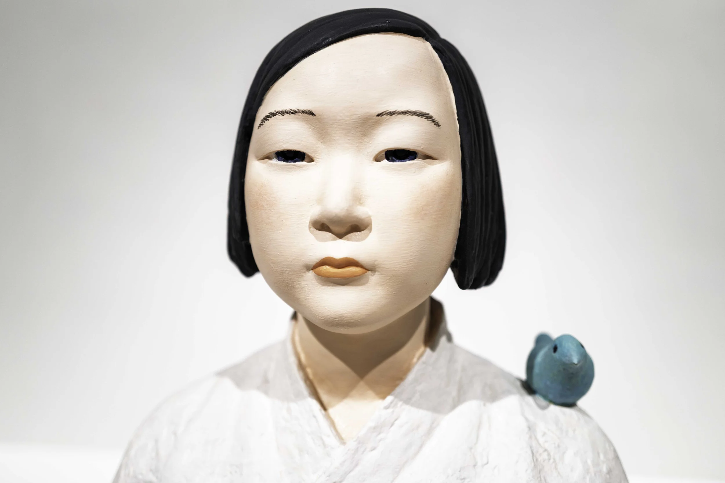 Close-up of the Girl of Peace face with blue bird on shoulder, Museum of Forbidden Art Barcelona — Leica Q3
