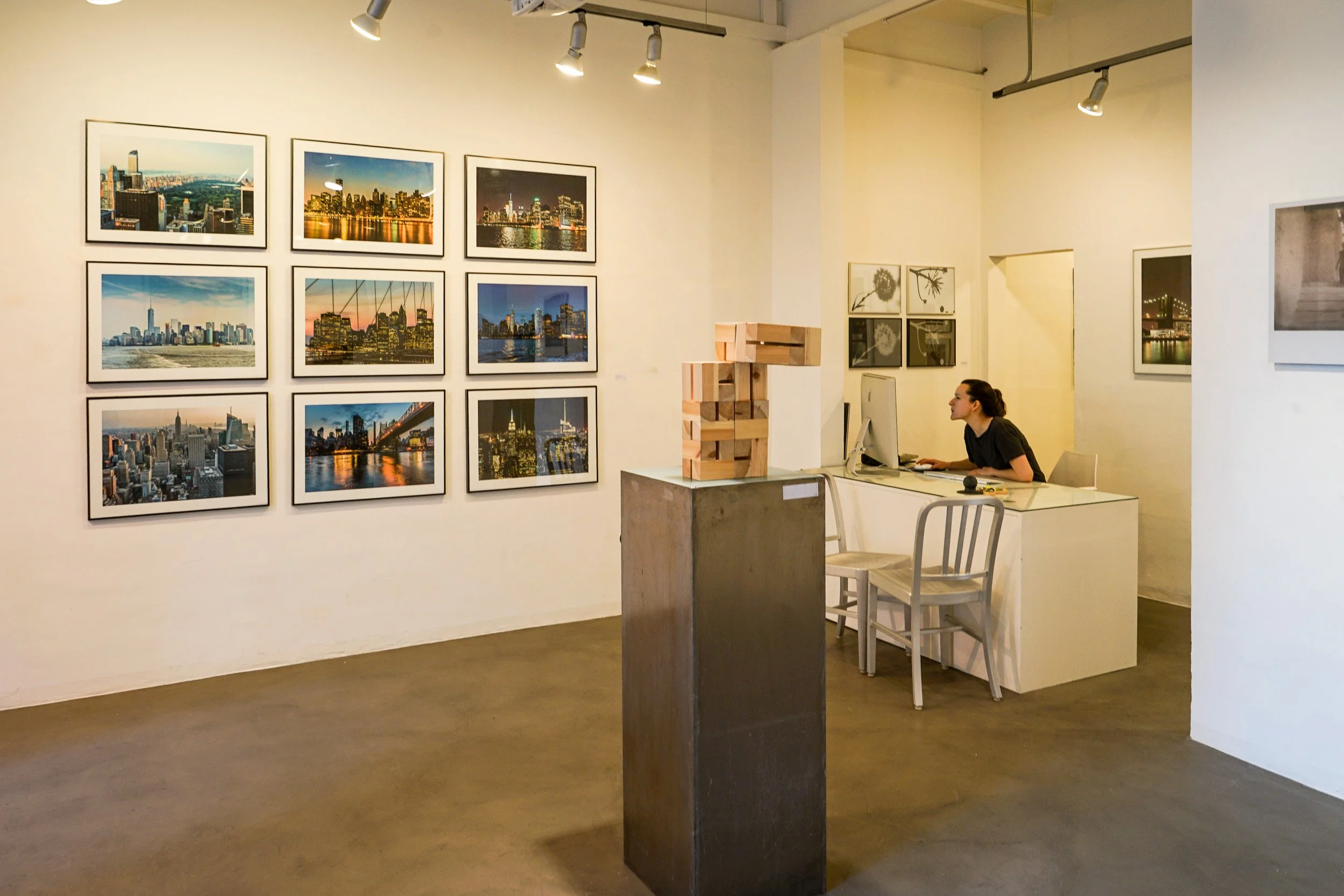 Nine framed New York cityscapes by Cosme Lapena on the wall of espai [b] gallery, Barcelona, during the En Sèrie exhibition, 2016.
