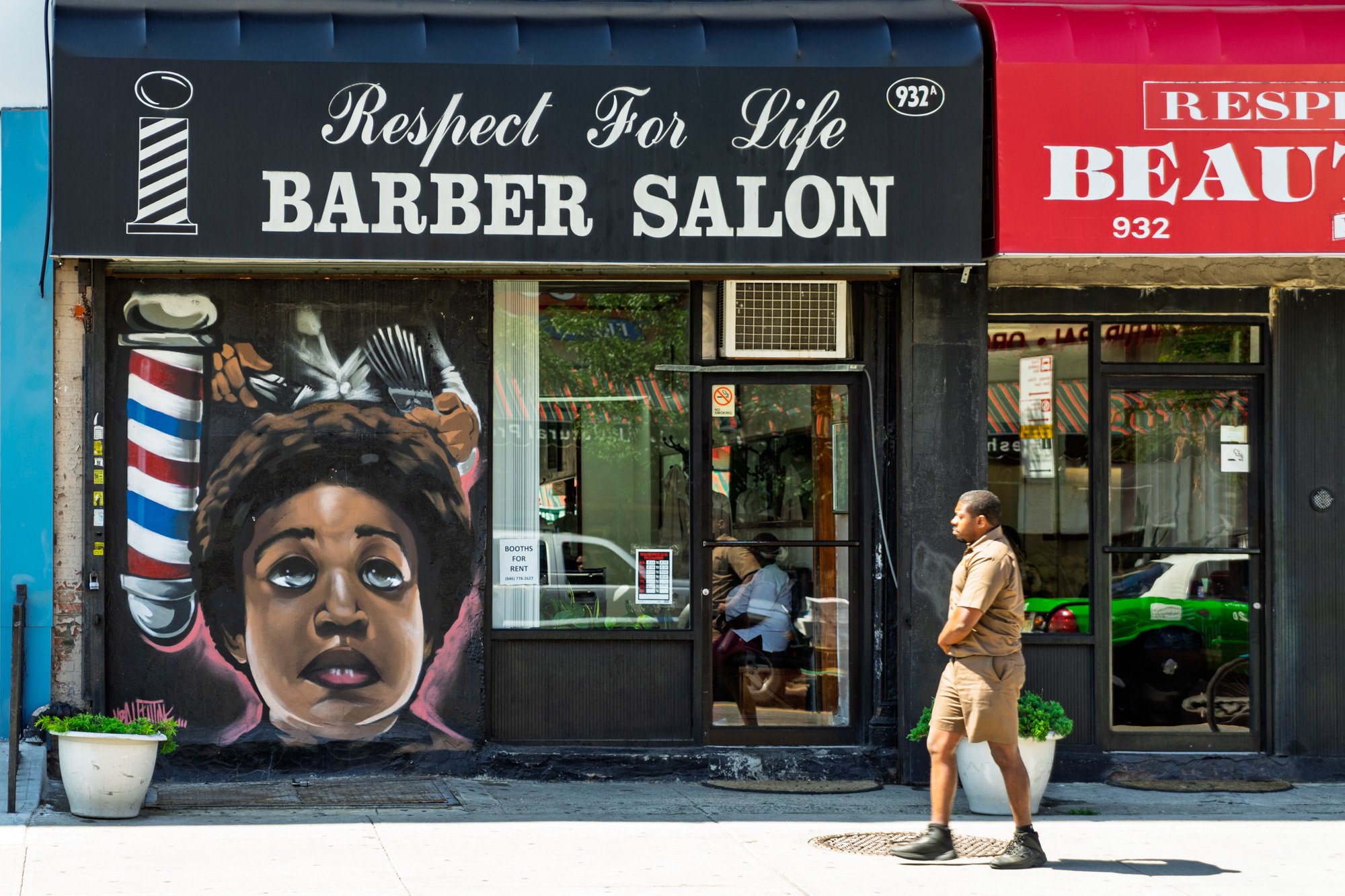 Respect for Life Barber Salon with portrait mural on window, man walking past, Brooklyn — Sony a7II