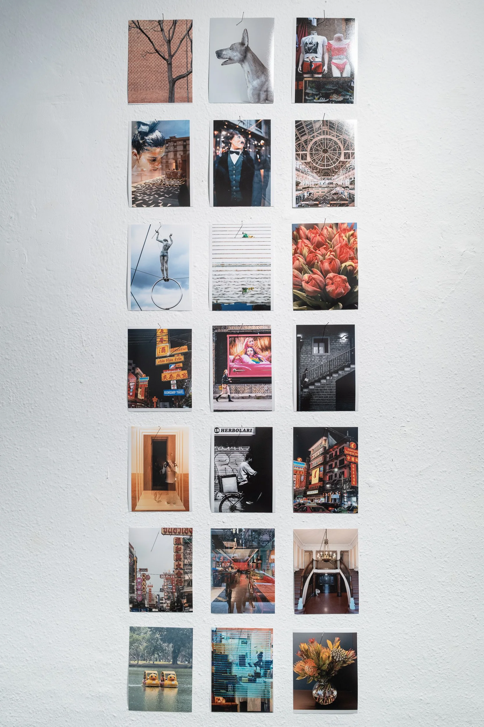 Column of 15x20 cm colour and black-and-white prints on a white gallery wall, espai[b] Barcelona — Leica Q3