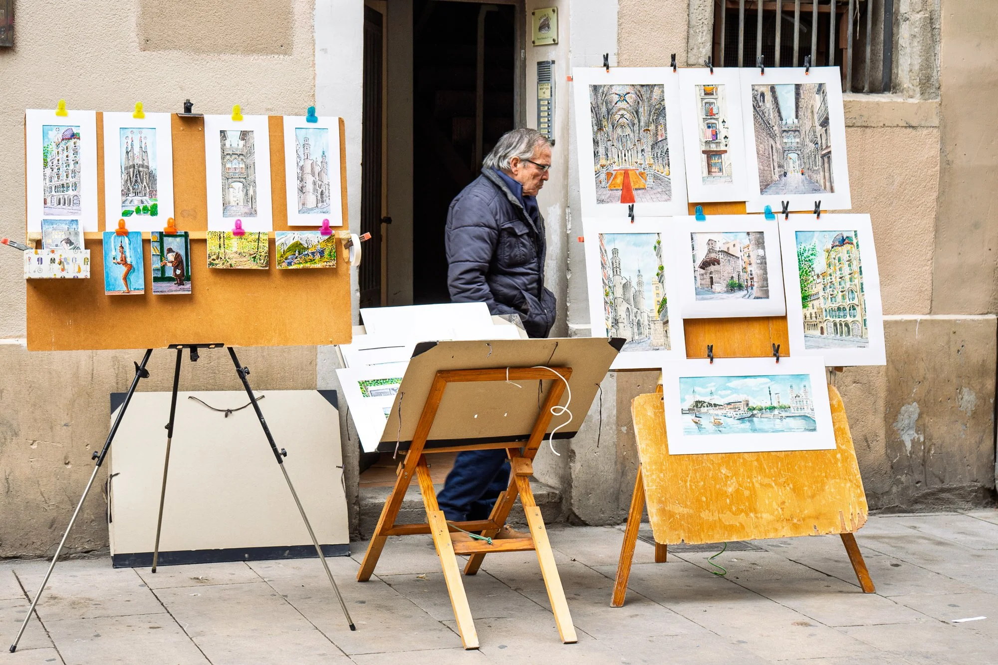 Artisan's watercolour prints of Barcelona landmarks displayed on an easel in El Born