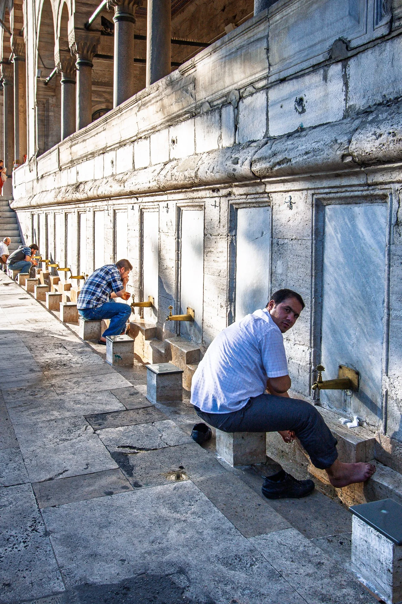 Men washing their feet at mosque ablution fountains, Sultanahmet