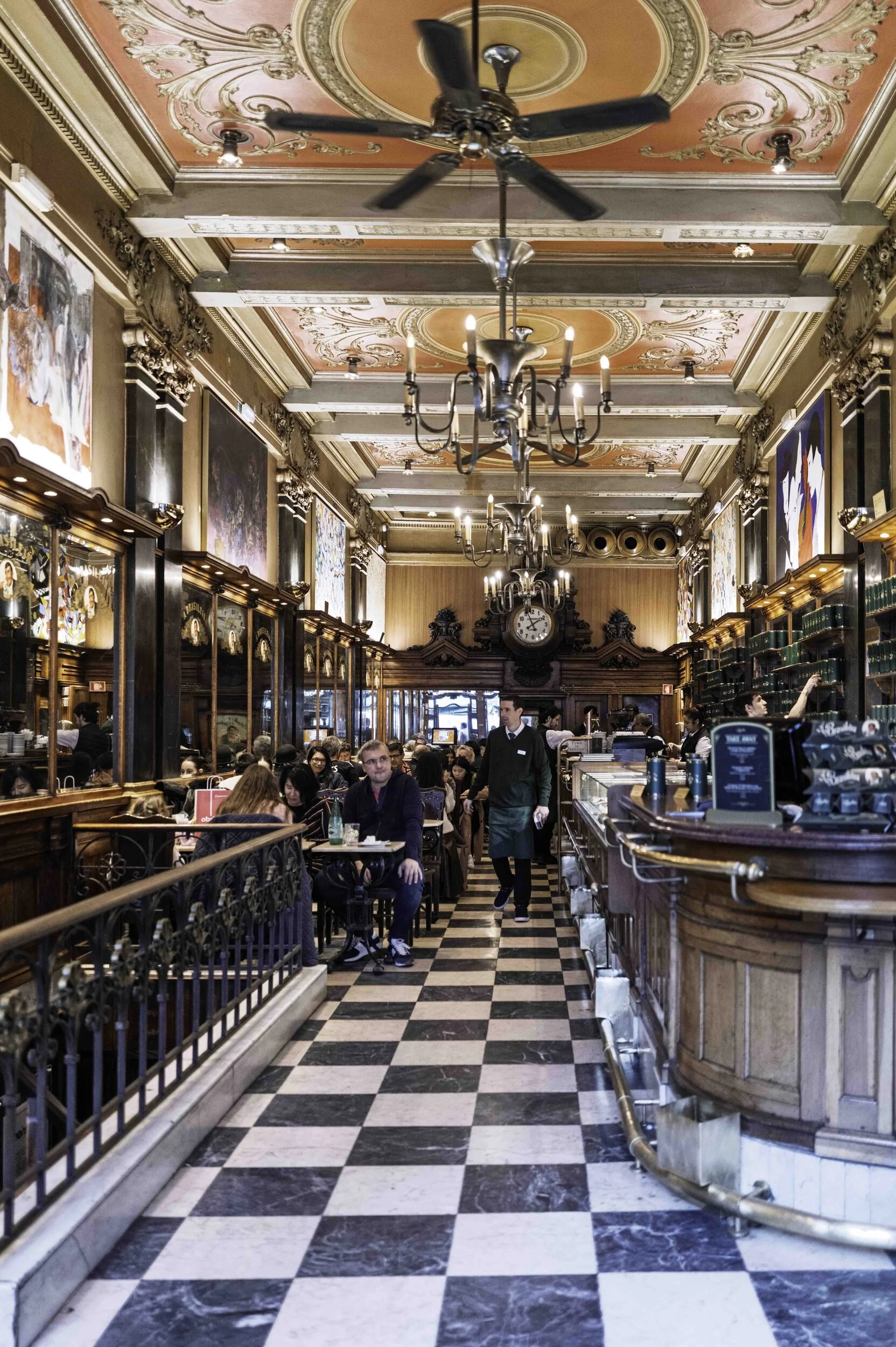 Ornate interior of a historic Lisbon café with chequered floor and chandelier — Leica Q3
