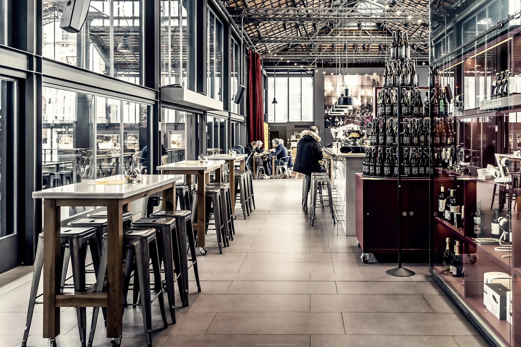 Café tables on the upper level overlooking the Born archaeological site — Sony a7R IV