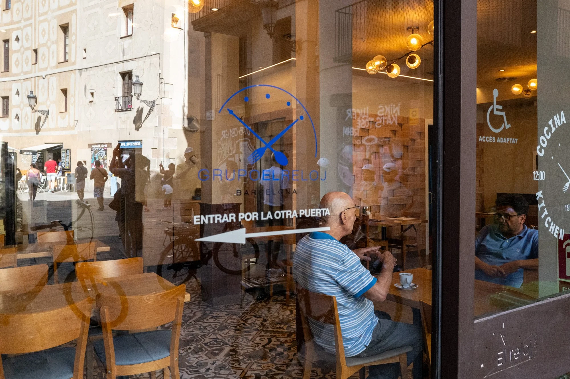 Man having coffee reflected in a café window, street photography in Barcelona – bCLPhoto