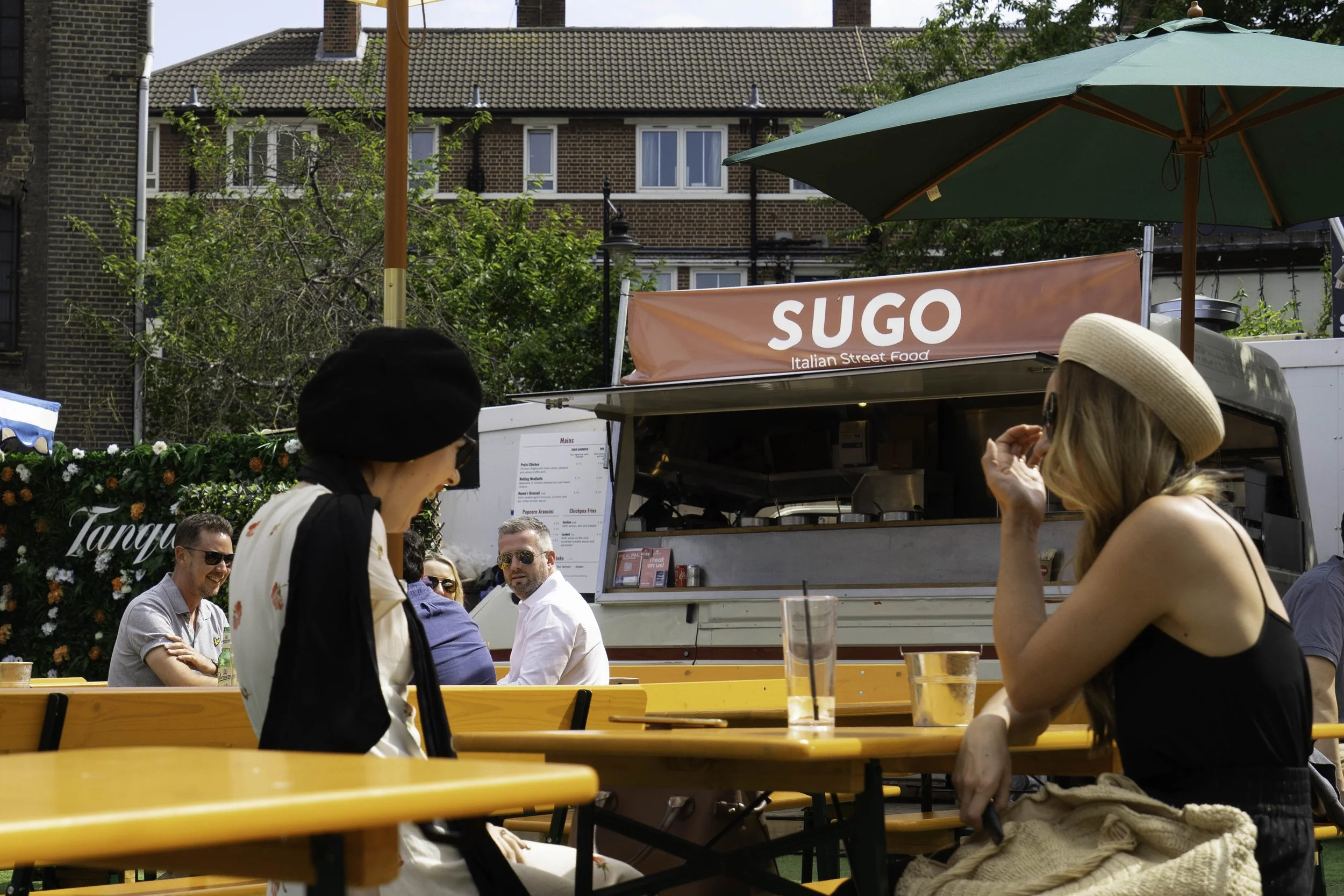 Girls chatting animatedly and laughing in a bar in London – bCLPhoto