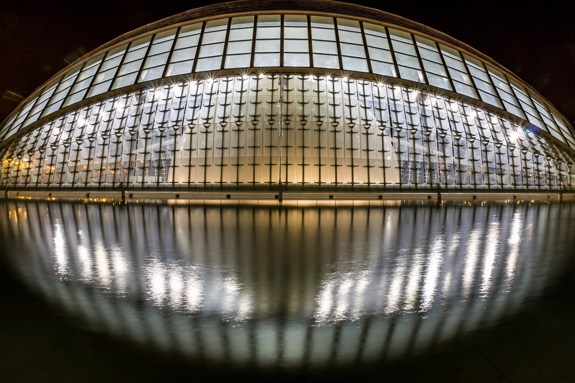 Long exposure of L'Hemisfèric at night with mirror reflection on the still water, City of Arts and Sciences, Valencia -bclphoto