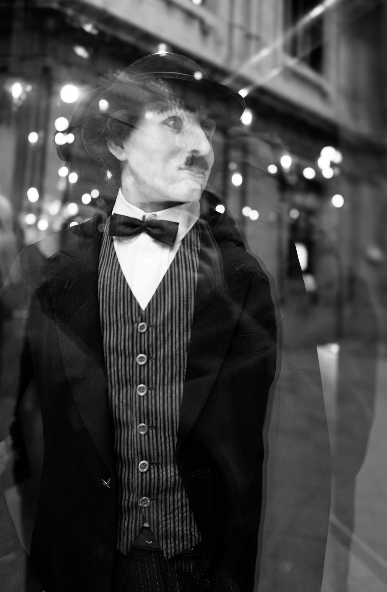 Charlie Chaplin mannequin seen through a shop window at night, Gothic Quarter Barcelona — Leica Q3