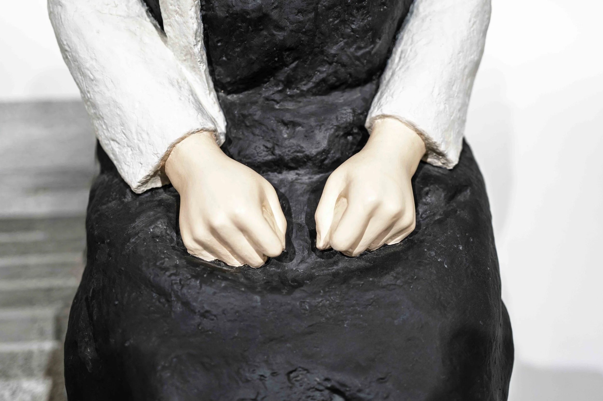 Detail of the Girl of Peace clenched hands on black skirt, Museum of Forbidden Art Barcelona — Leica Q3