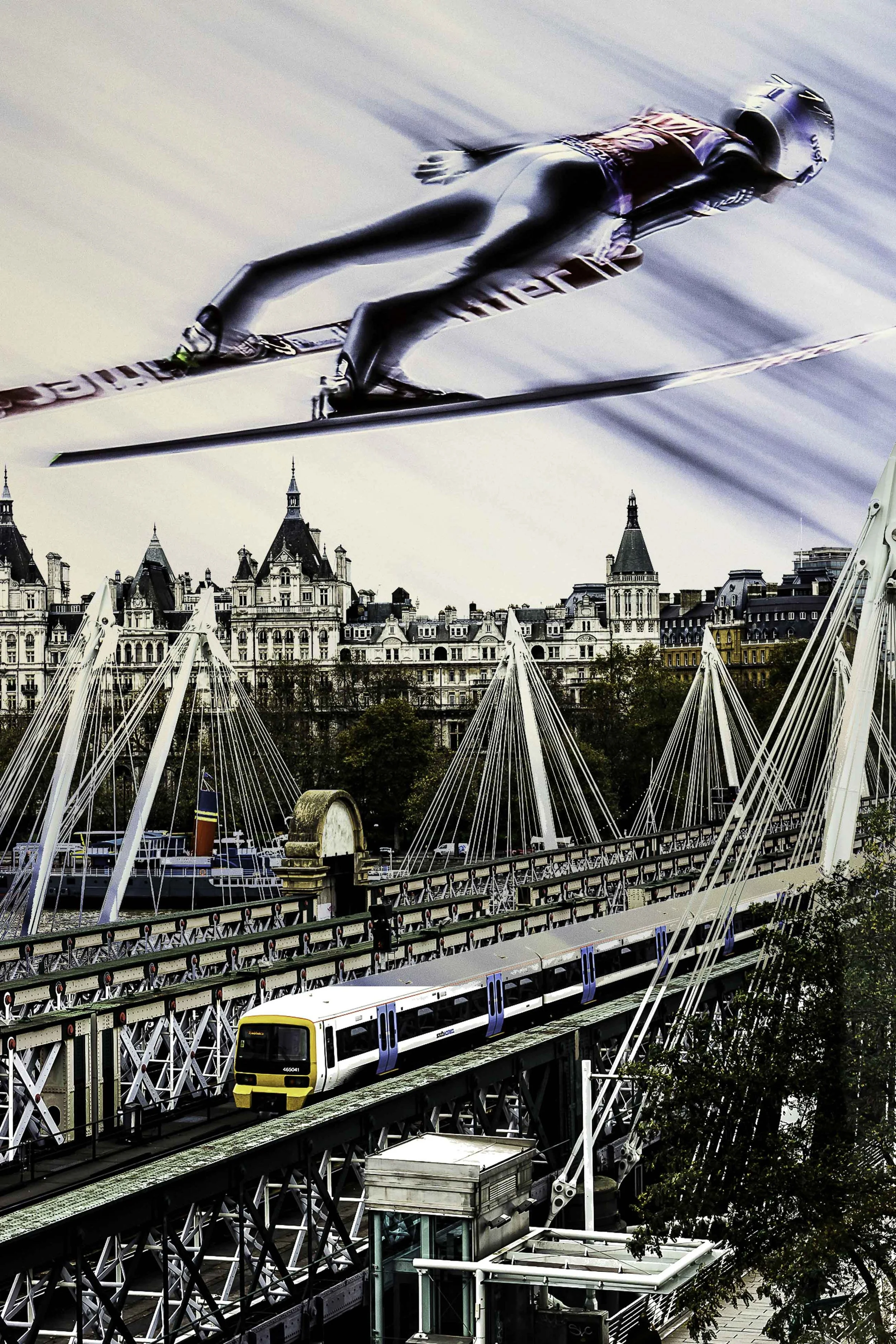 Skier flying over the city, watching a train passing over a bridge and the buildings surrounding it.