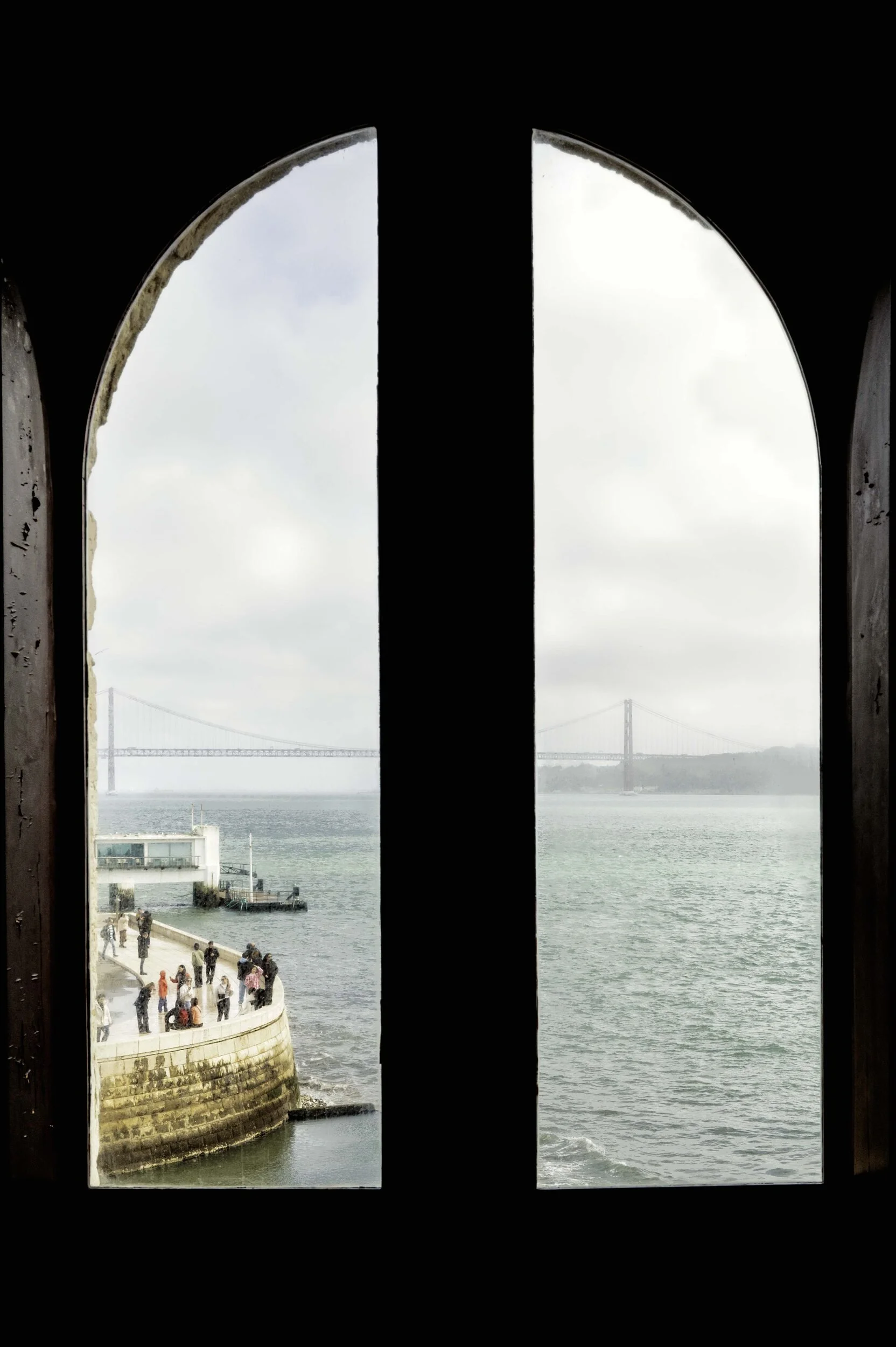 Tagus river and 25 de Abril Bridge through gothic arched windows, Torre de Belém, Lisbon — Leica Q3